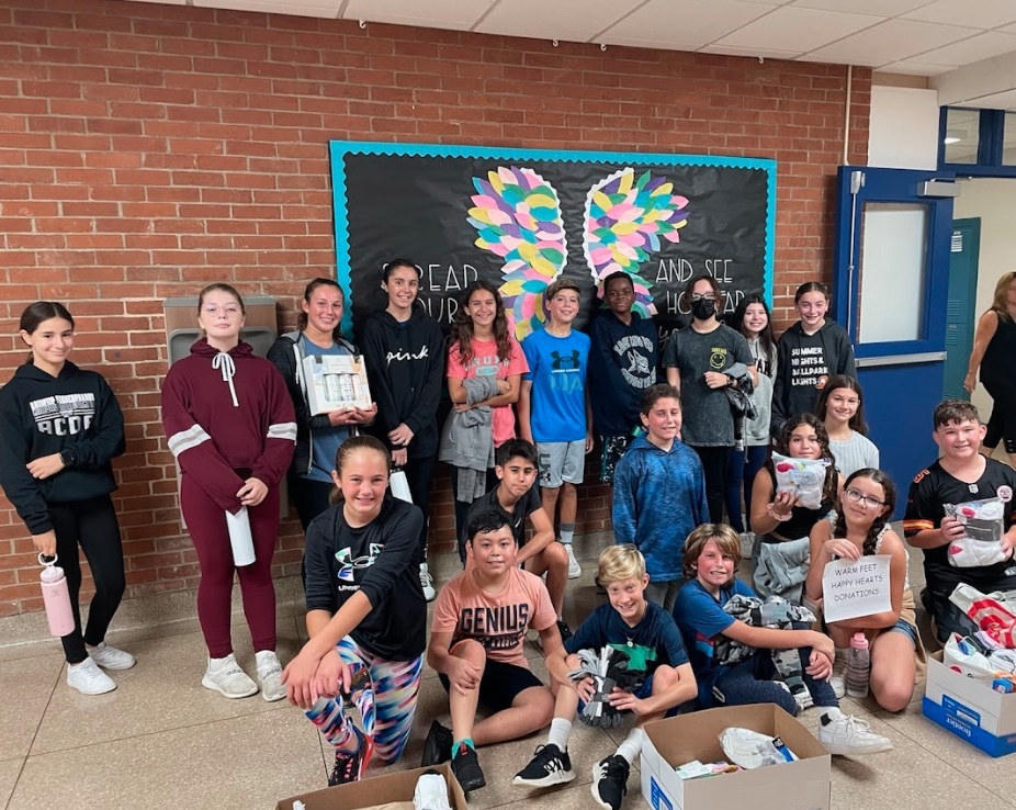 Sixth grade students at Eastport Elementary School recently ran a sock collection for the Warm Feet, Happy Hearts Drive. The students collected three boxes of socks for local shelters. COURTESY EASTPORT-SOUTH MANOR SCHOOL DISTRICT