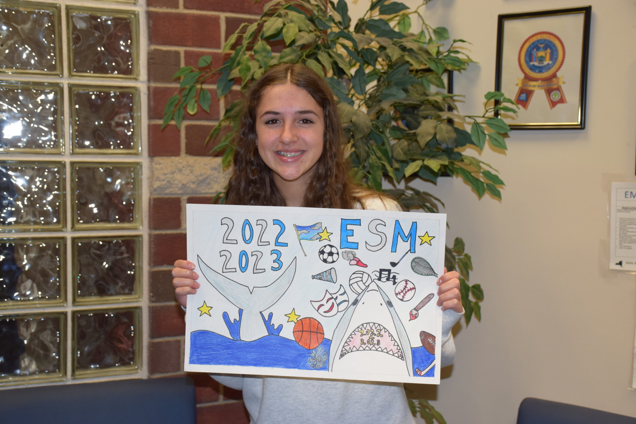 The artwork of Eastport-South Manor Jr.-Sr. High School student Emily Tracy was
chosen for the cover of the 2022-23 yearbook. Tracy’s design was one of more than 100 photos or designs submitted and was chosen by the members of the Junior High Yearbook Club.
Her design depicts various symbols representing aspects of the junior high school’s educational and extracurricular programs. COURTESY EASTPORT-SOUTH MANOR SCHOOL DISTRICT