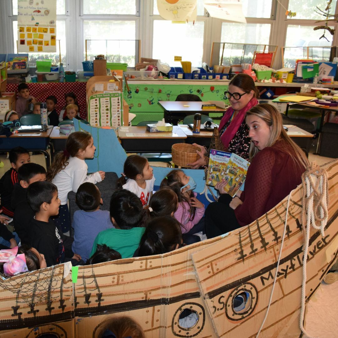Hampton Bays Elementary School kindergartners learned about the difficult voyage the pilgrims made across the Atlantic Ocean in a makeshift Mayflower as part of teacher Mary Beth Motz’s annual Mayflower reenactment on November 22. While on the “ship,” Motz read “The First Thanksgiving” by Linda Hayward to her class. COURTESY HAMPTON BAYS SCHOOL DISTRICT