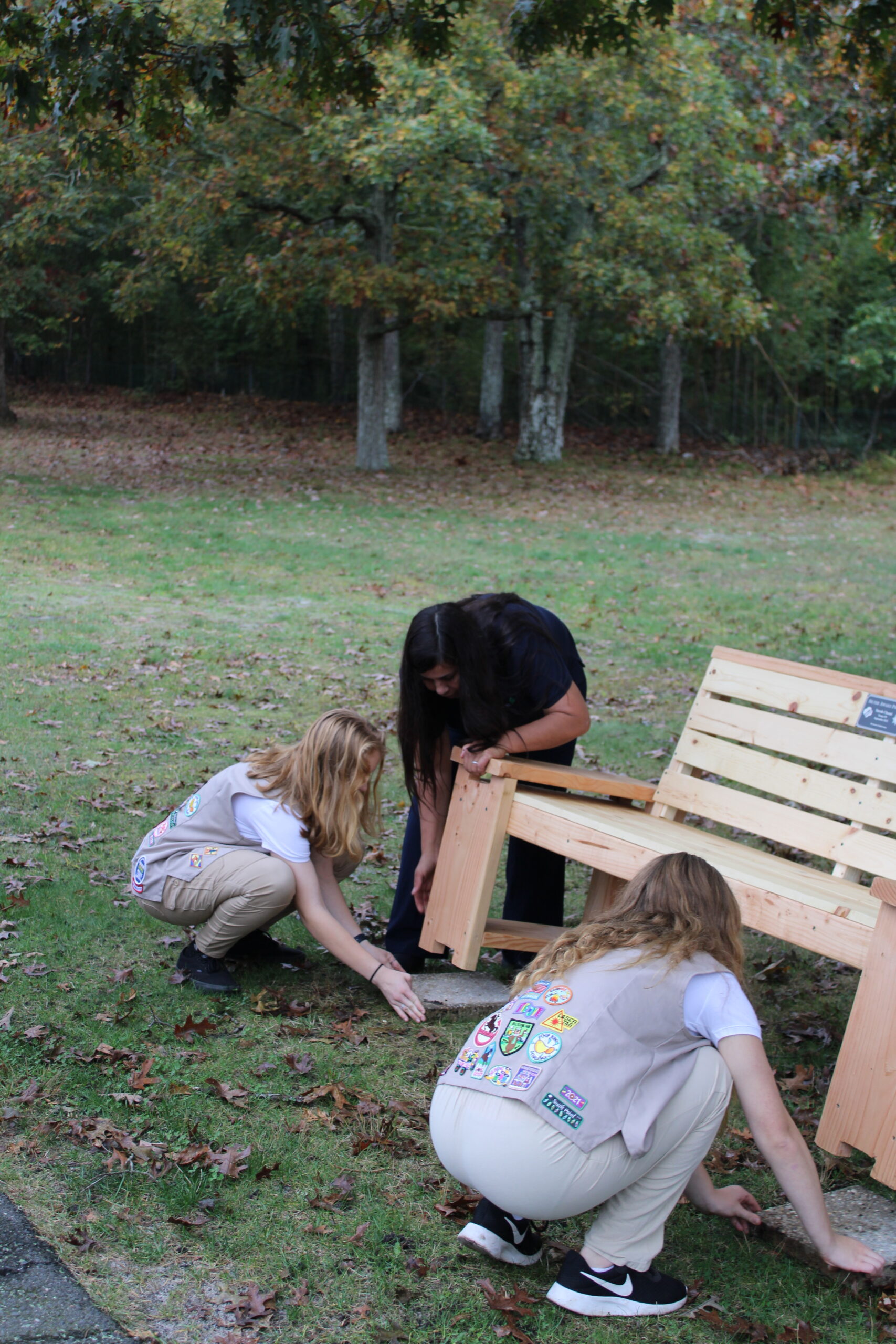Brianna Farrell, Laura Farrell Caitlyn Lupia, lifting and adjusting one of the benches at St. Joseph's Villa. ELIZABETH VESPE