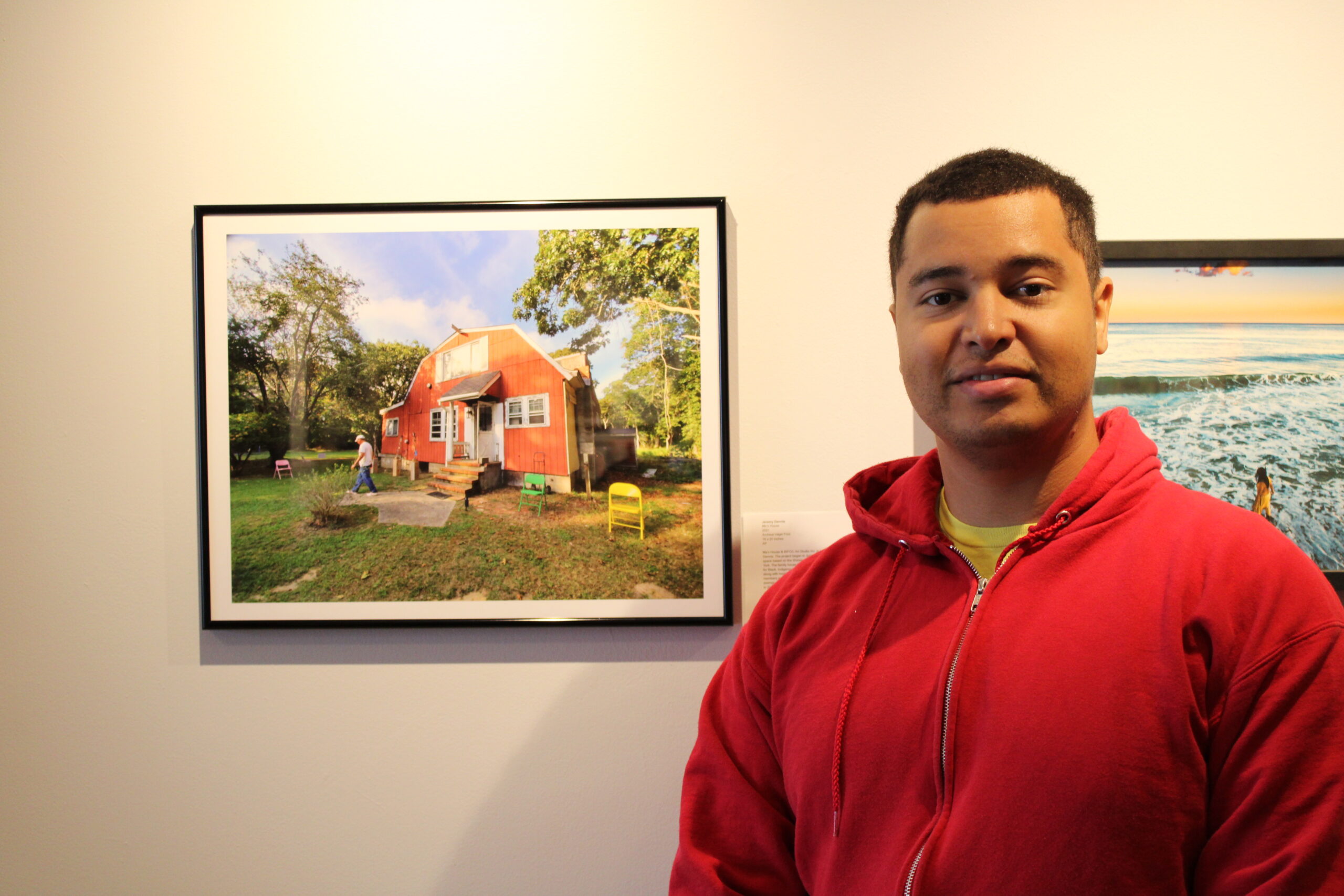 Artist Jeremy Dennis with a photo of 