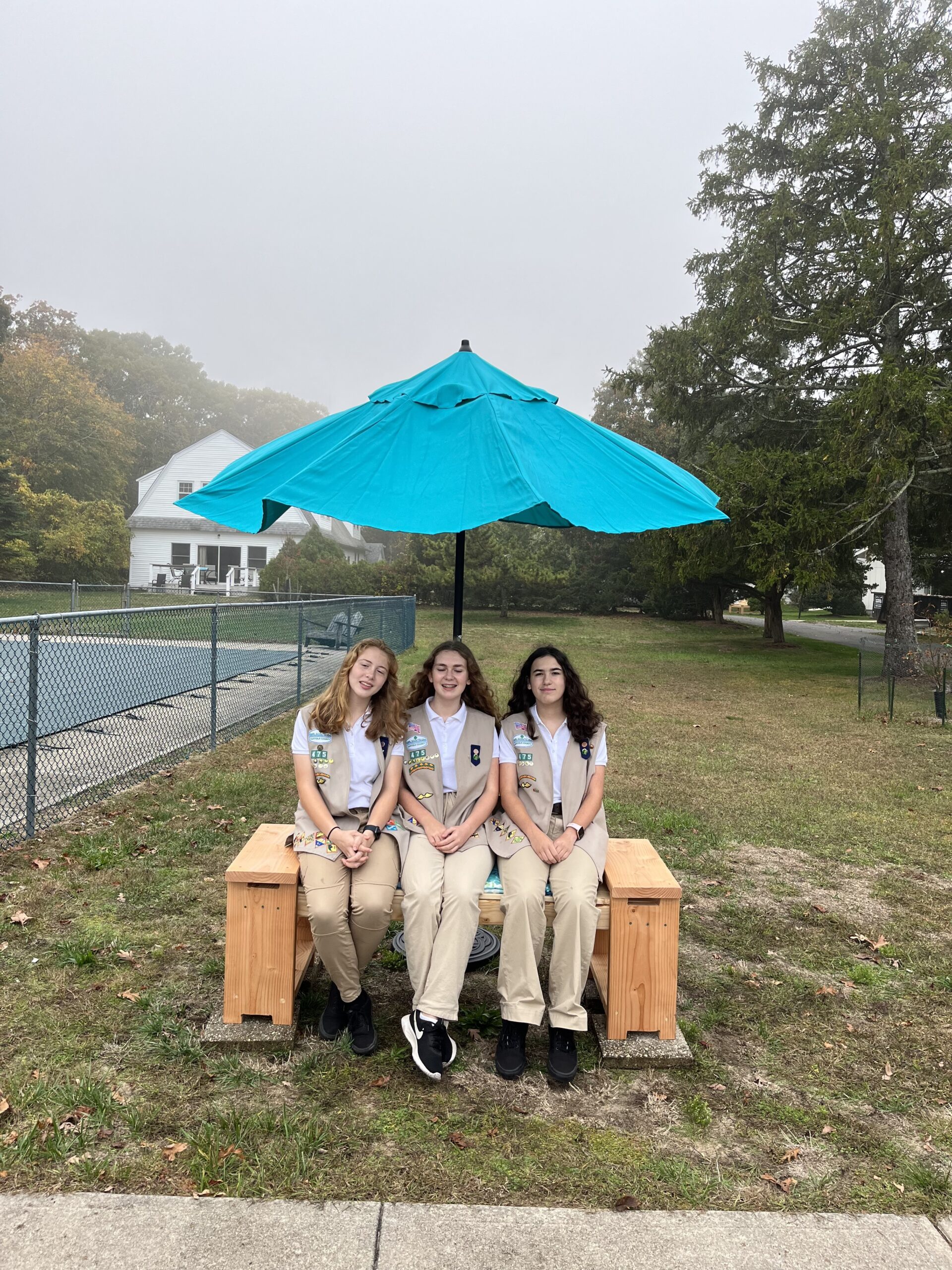 Brianna Farrell, Sarah Chami and Caitlyn Lupia posing near one of the benches they built for the nuns at St. Joseph's Villa.   ELIZABETH VESPE
