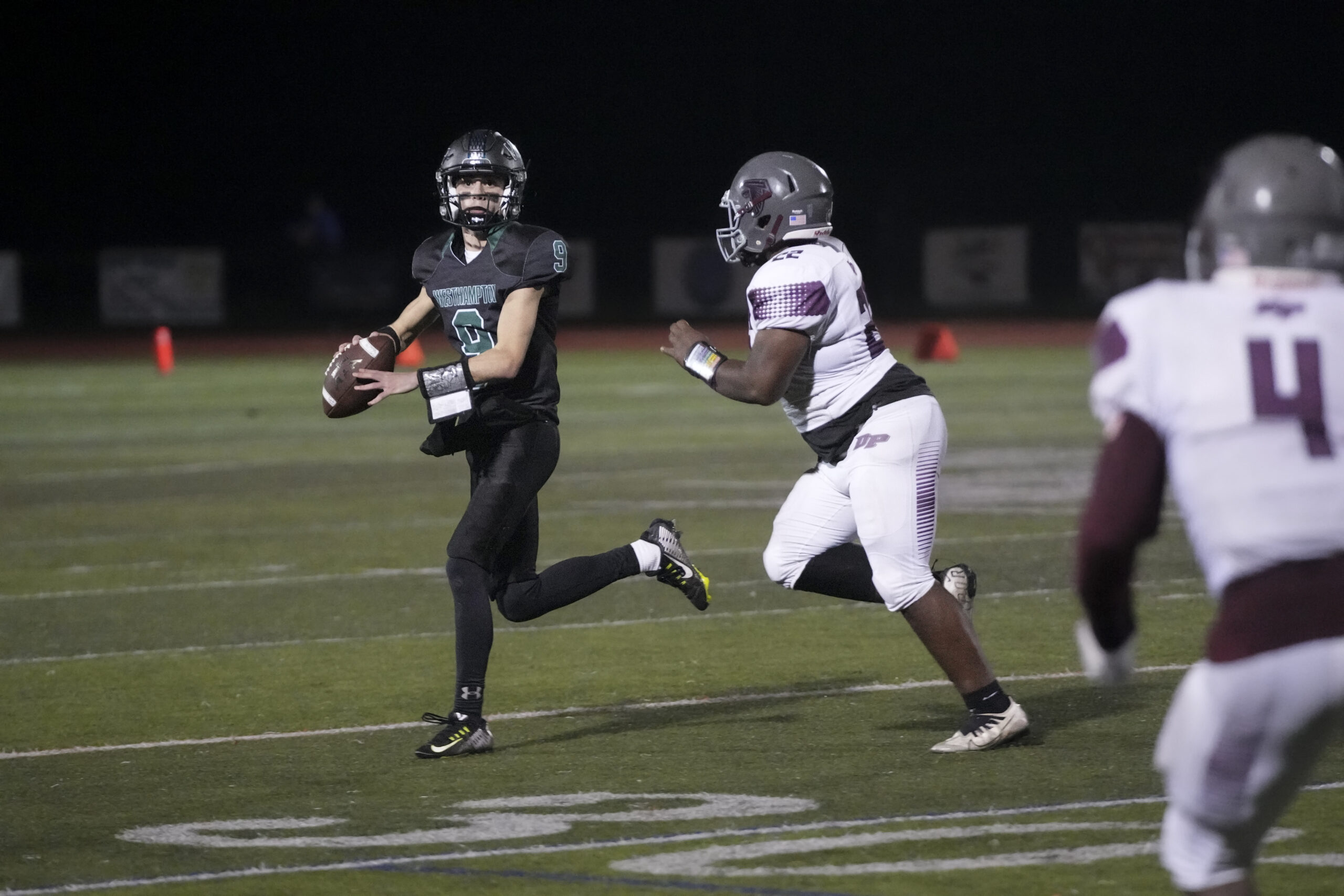 Westhampton Beach junior quarterback rolls out looking for junior receiver Michael LoRusso.   RON ESPOSITO