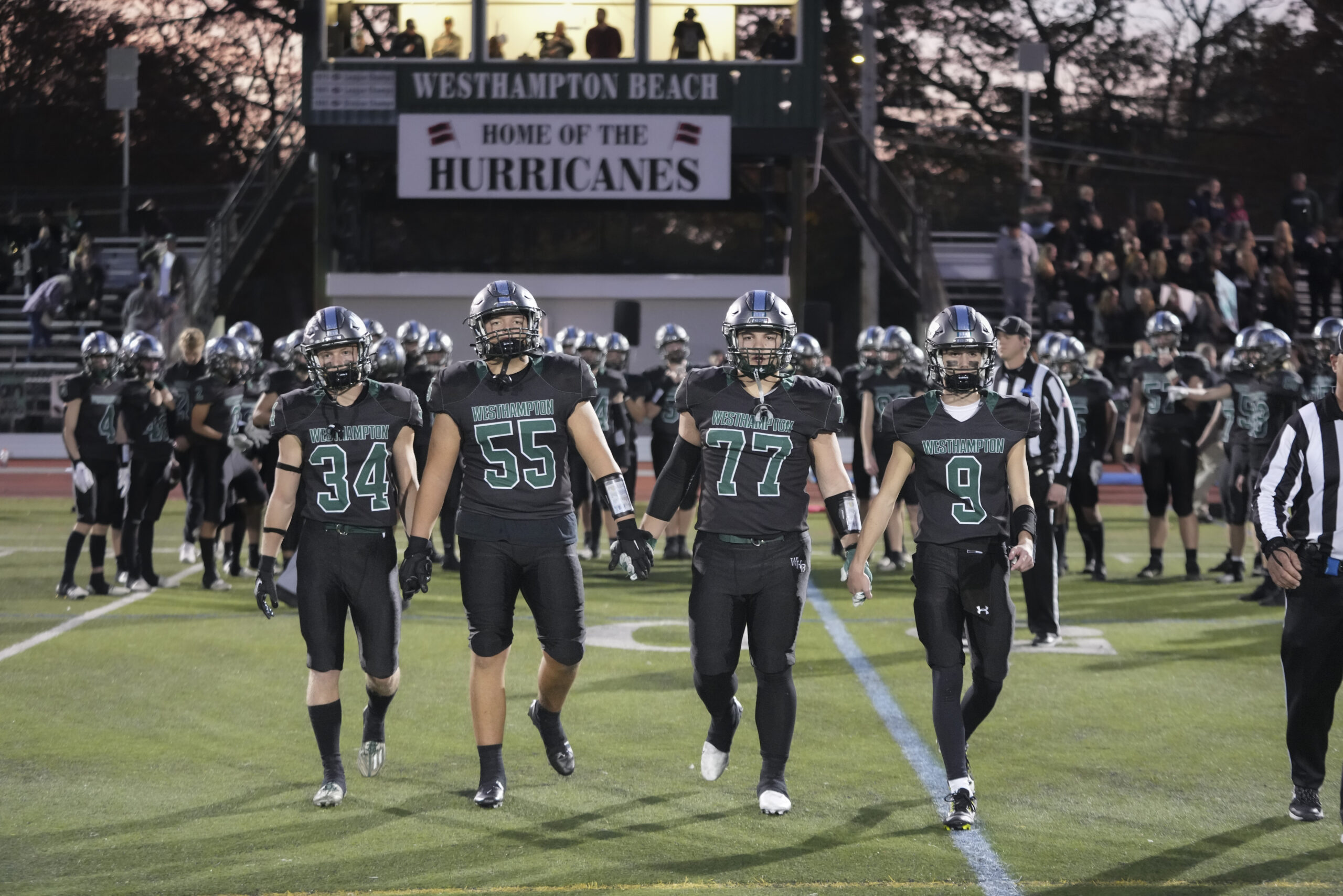 Westhampton Beach captains, from left, Luke Kilroy, Andrew Mensch, Noah Hebberd and Will Gambino head to midfield for the coin toss just prior to Friday night's home playoff game against Deer Park.    RON ESPOSITO