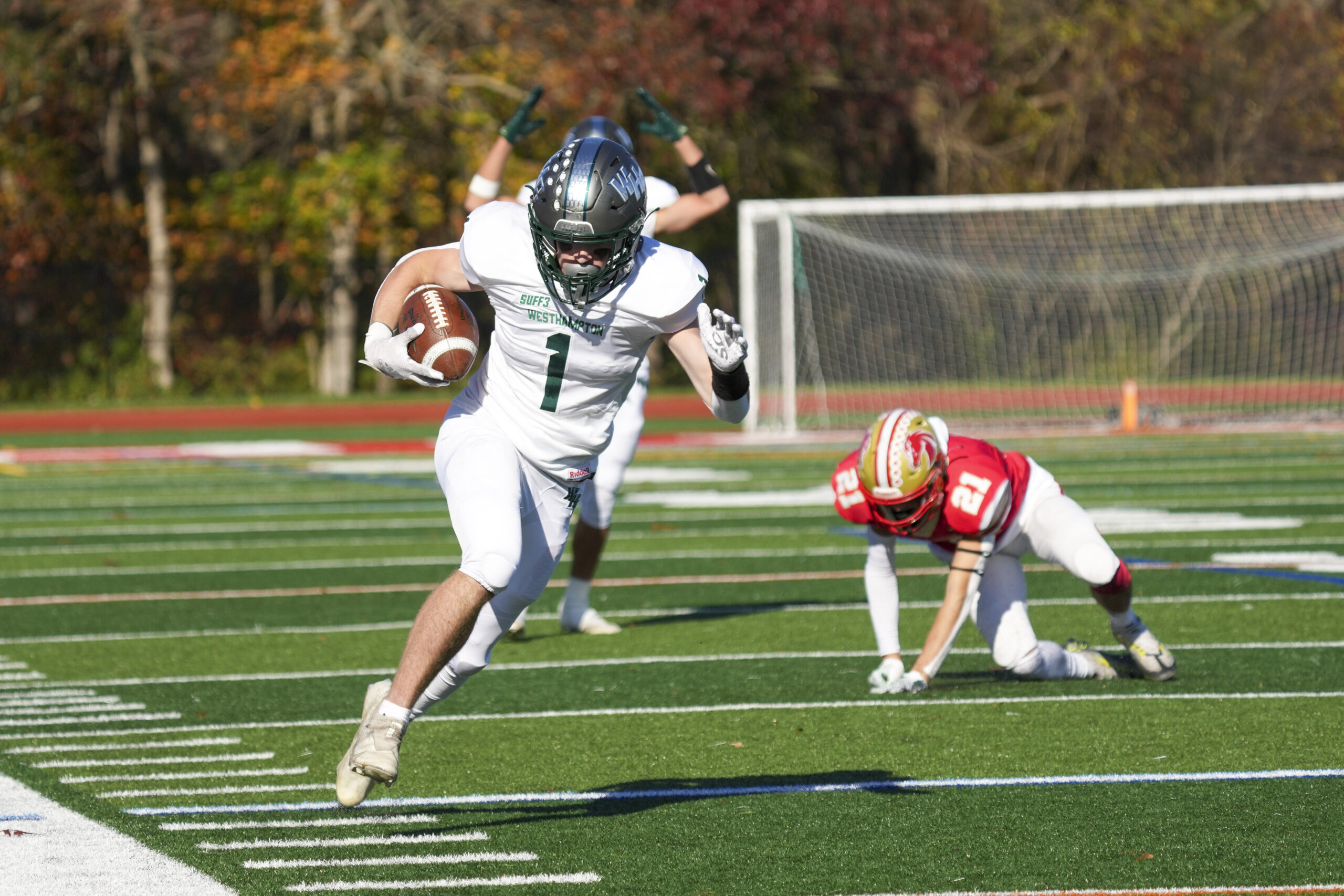 Westhampton Beach junior Kevin Smith sprints down the sideline after making a catch and eluding a Hills West defender.    RON ESPOSITO