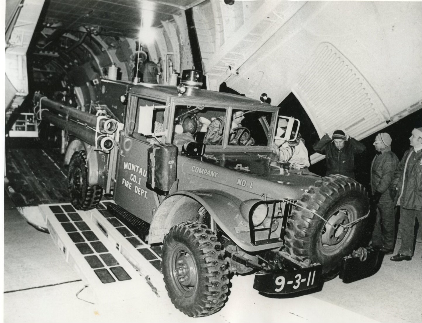 Members of the Montauk Fire Department load their World War II era fire truck onto a military cargo plane to be flown to Buffalo in February 1977 as part of an effort to help the city cope with a blizzard that dumped more than 100 inches of snow in three days.