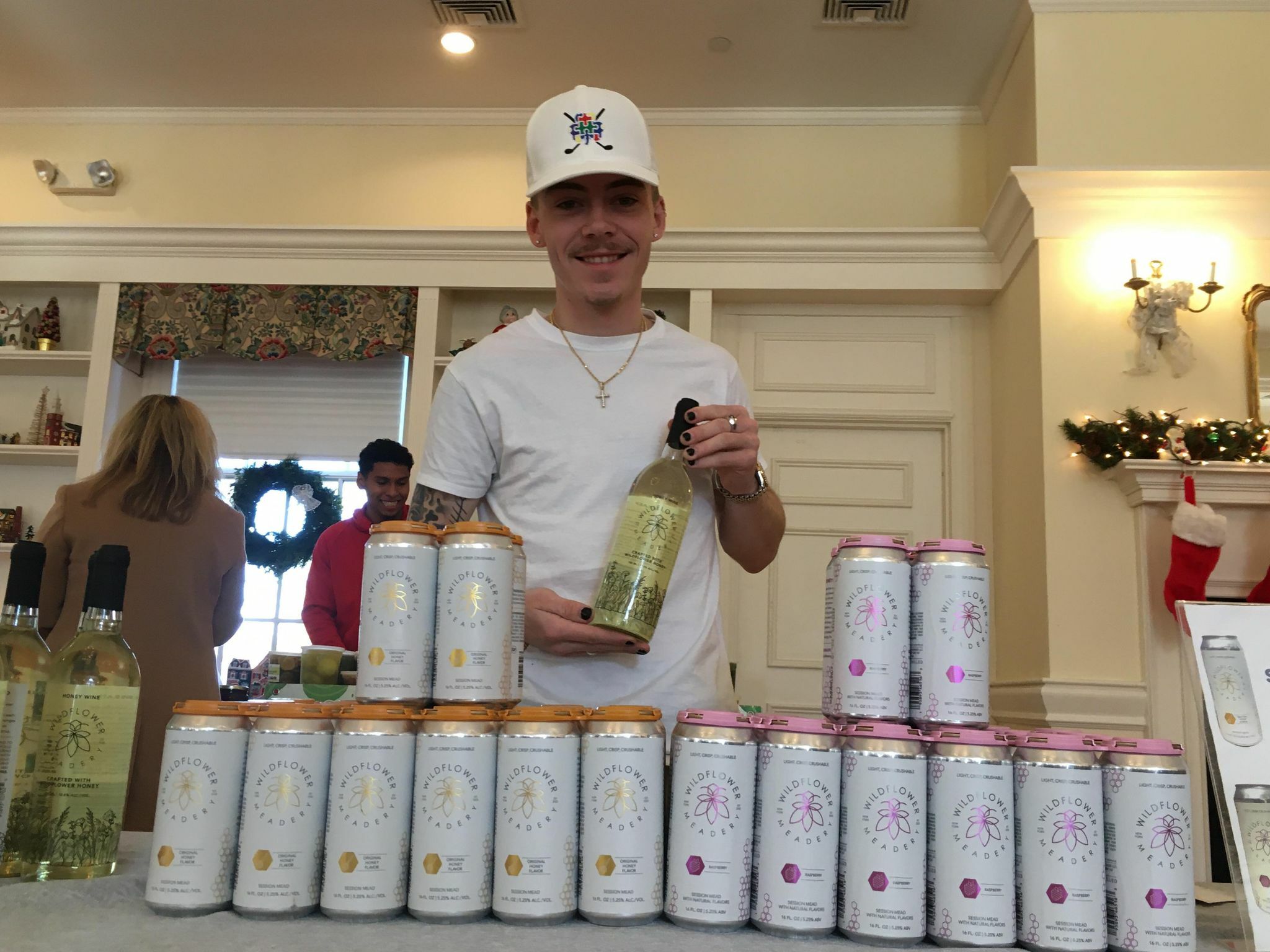 Liam Winters with Wildflower Meadery beverages made from honey at the indoor market hosted by the Greater Westhampton Chamber of Commerce.    KITTY MERRILL