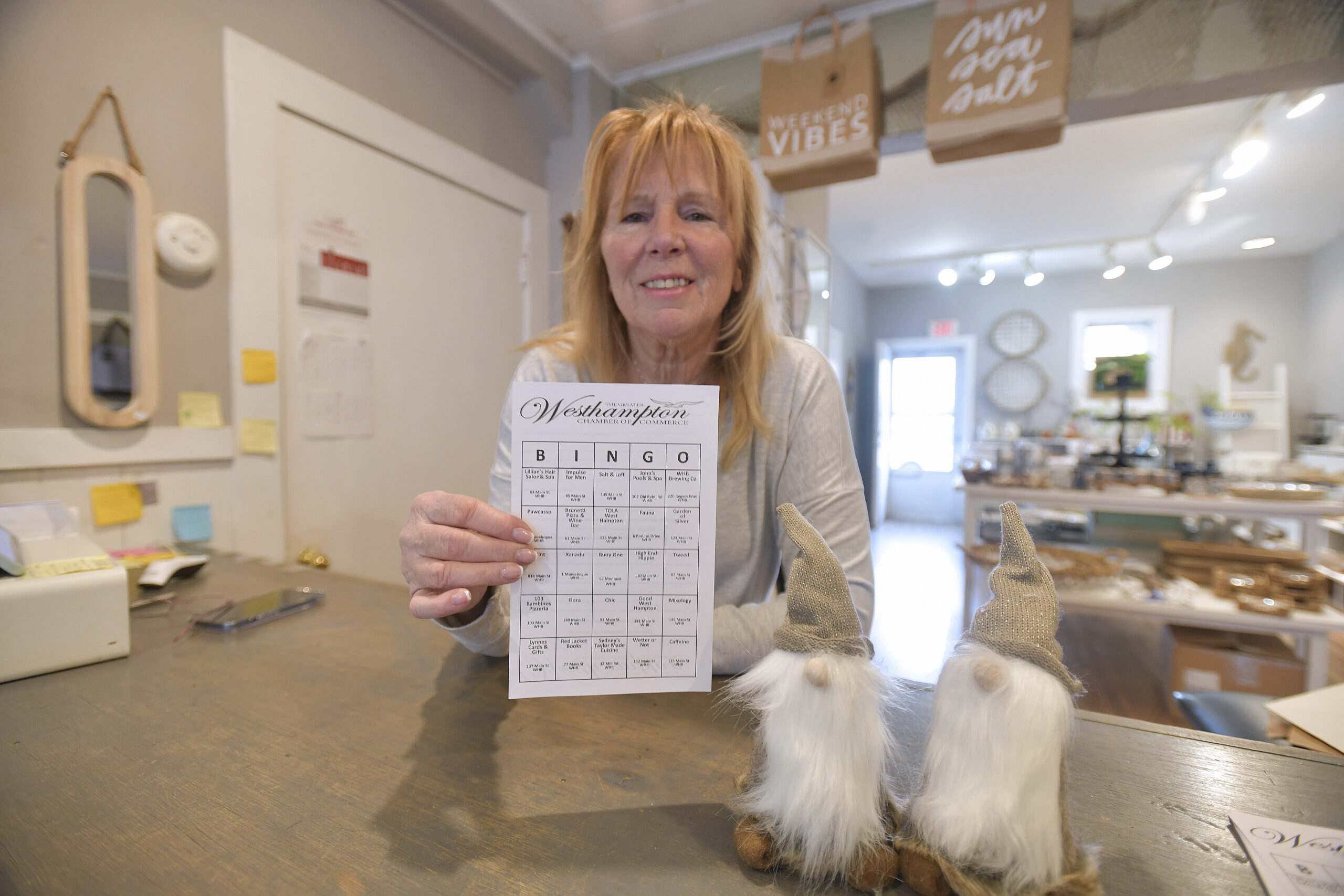 Claudio Perillo with a bingo card at Tweed, one of the participating businesses.   DANA SHAW