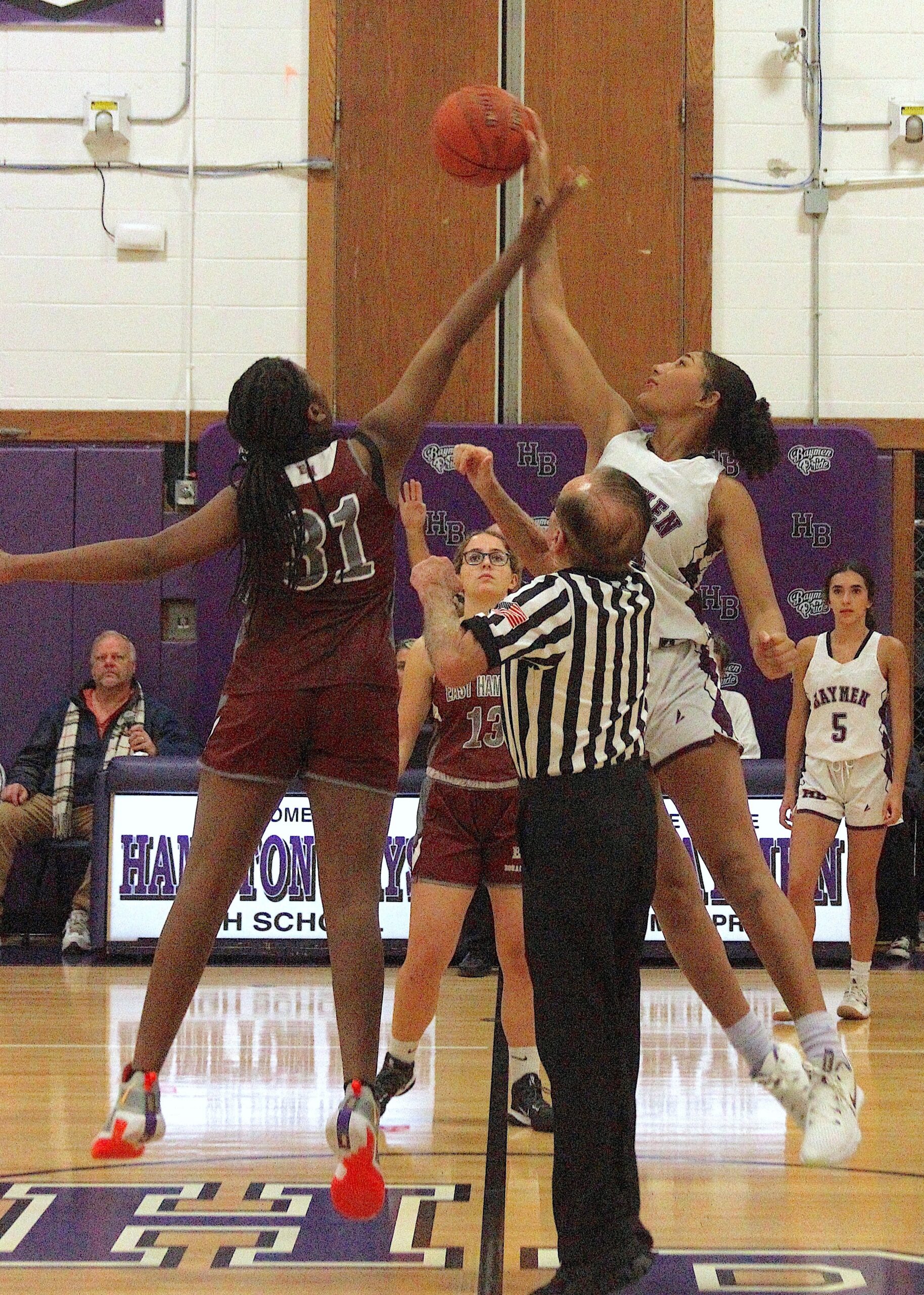 Freshman forward Kaili Moore reaches for the ball off the opening tipoff. DESIRÉE KEEGAN