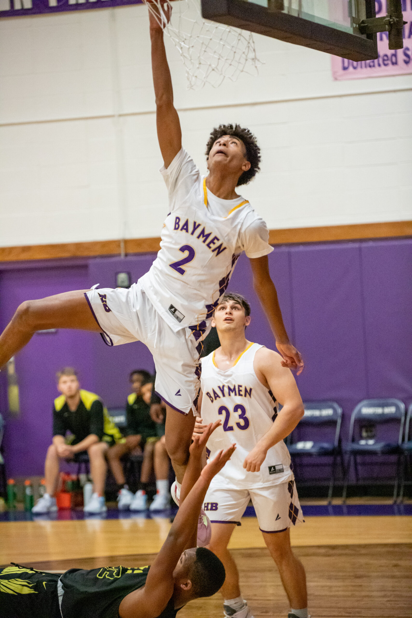 Senior Bayman Kazmin Johnson attempts to land a major dunk but is instead called for a foul.    MICHAEL O'CONNOR