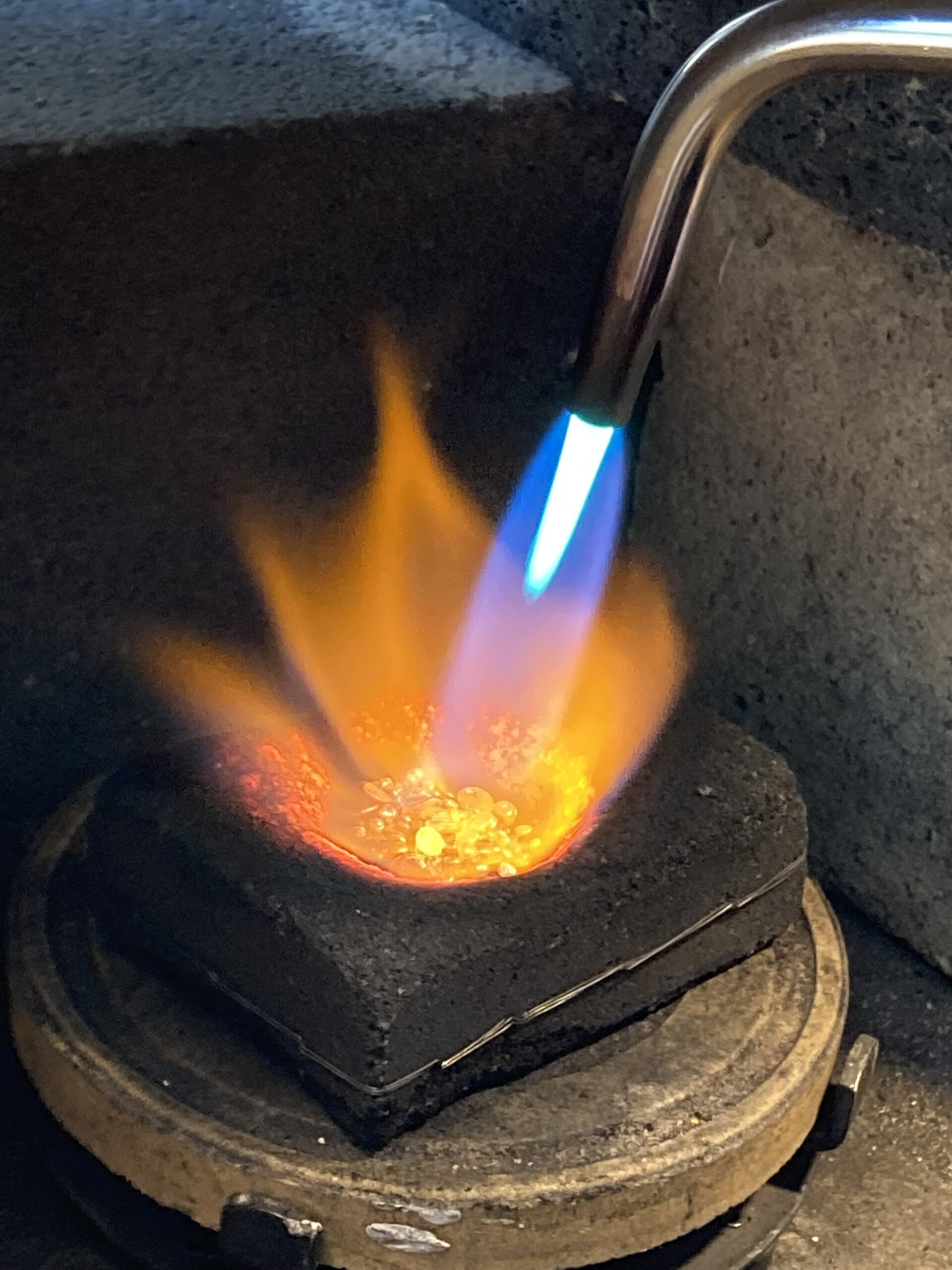 Gold smelting in Lois Gore's workspace.