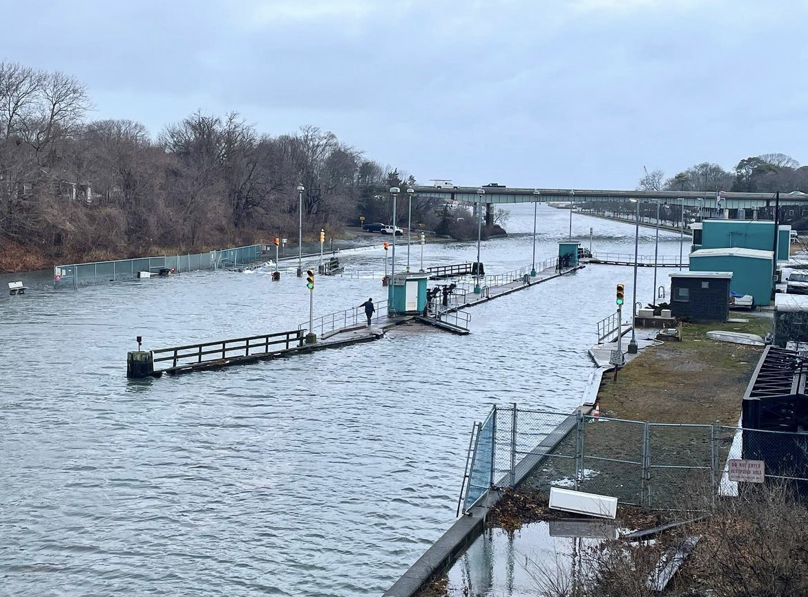 Abnormally high tides combined with the surge from Thursday night's storm caused unprecedented flooding along parts of the South Shore on Friday morning, including at the Shinnecock Canal, where the water overtopped the canal locks.