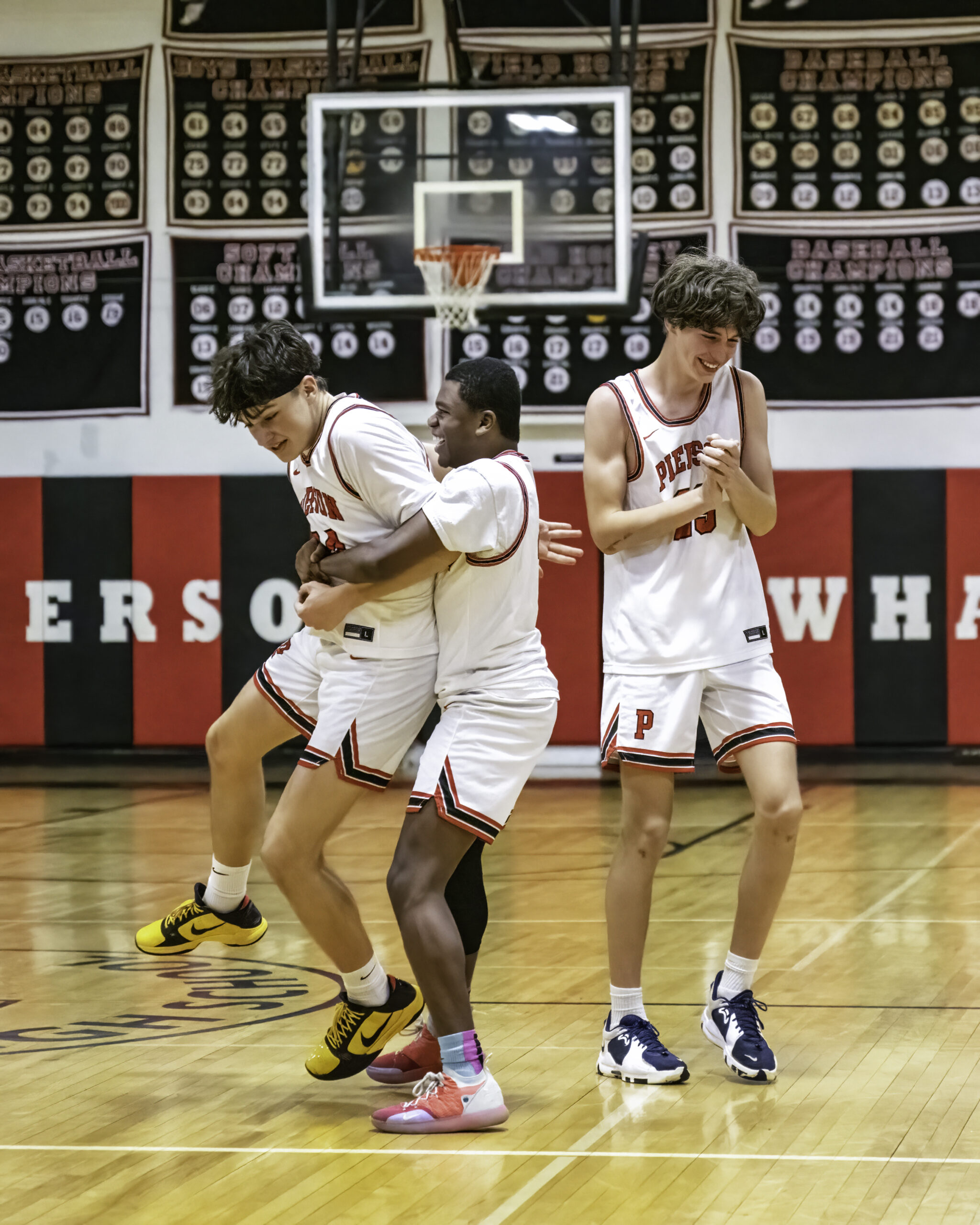 Aven Smith is congratulated by Keanu King and Kyle Seltzer following his game-tying three-pointer with 11 seconds left in the game. MARIANNE BARNETT