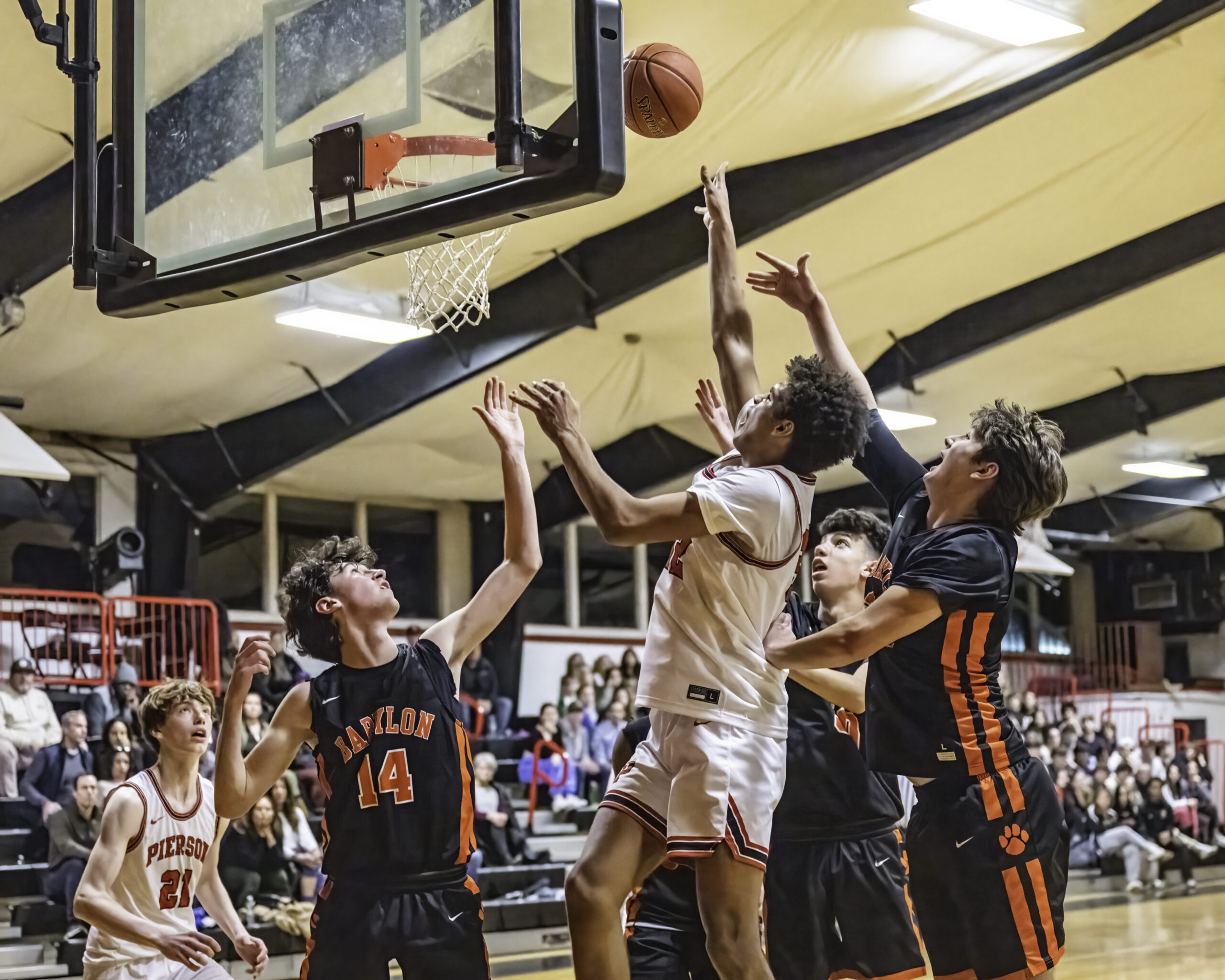 Junior Charlie McLean shoots in the middle of a swarm of defenders. MARIANNE BARNETT