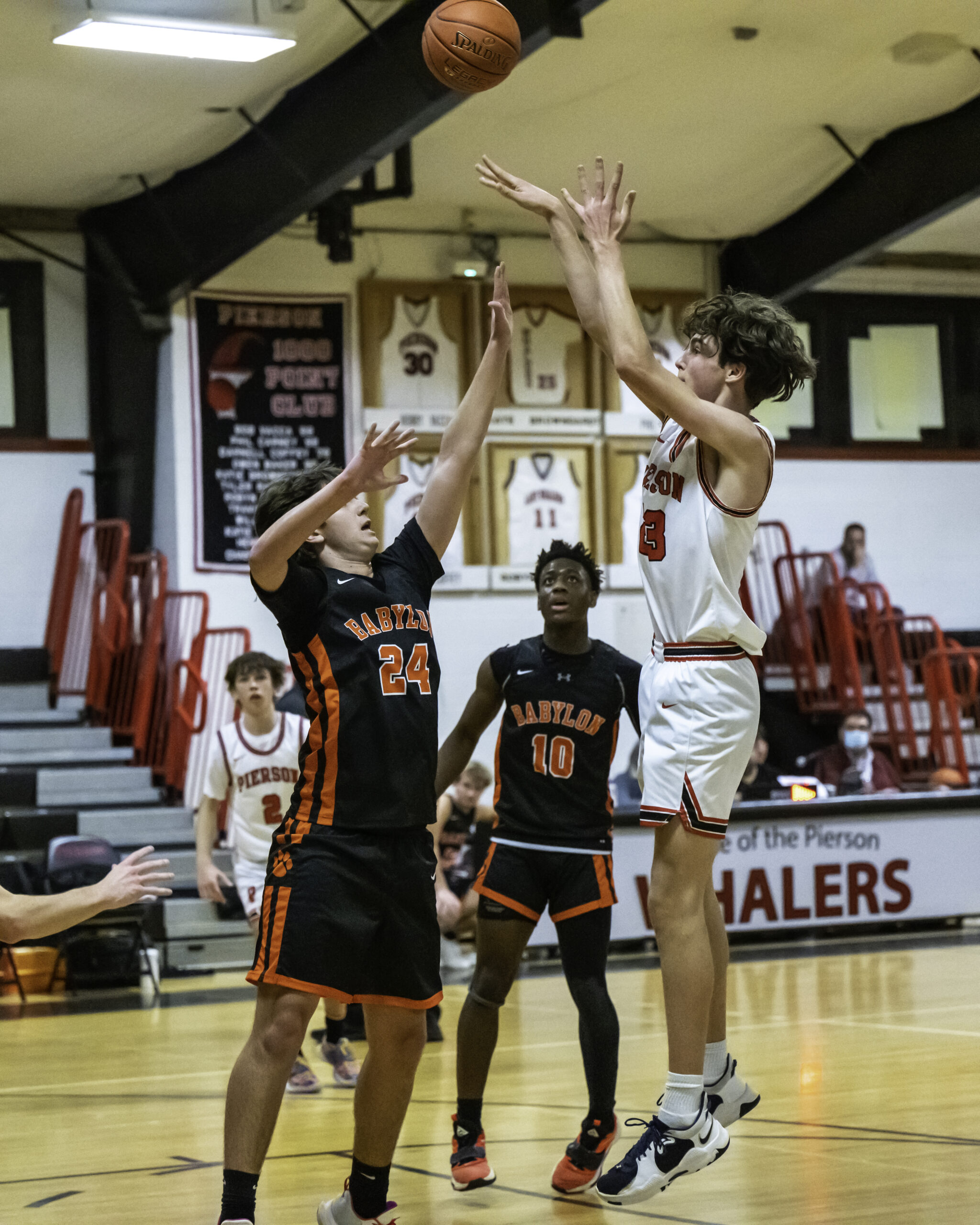 Freshman Kyle Seltzer shoots and scores over Babylon's Trevor Thuma. MARIANNE BARNETT