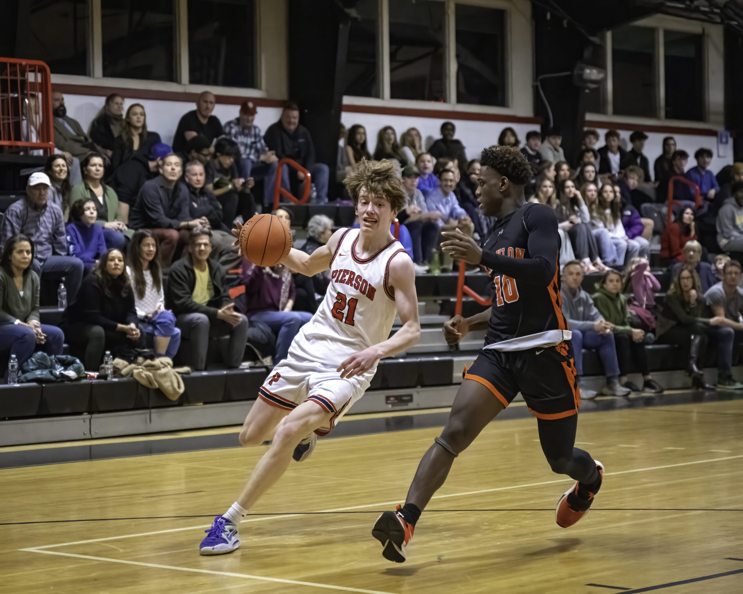 Junior Luke Seltzer drives around Babylon's Sincere McDougal. MARIANNE BARNETT