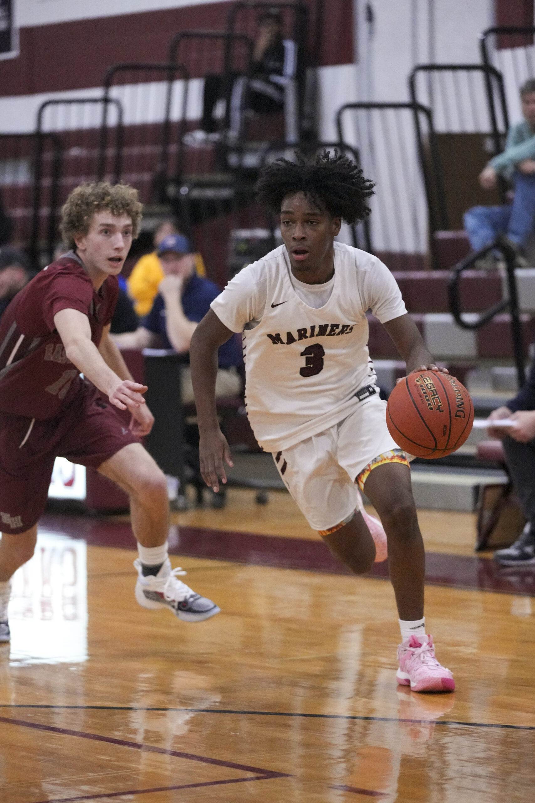 Senior Mariner Derek Reed drives passed senior Bonacker Ben Zazula.    RON ESPOSITO