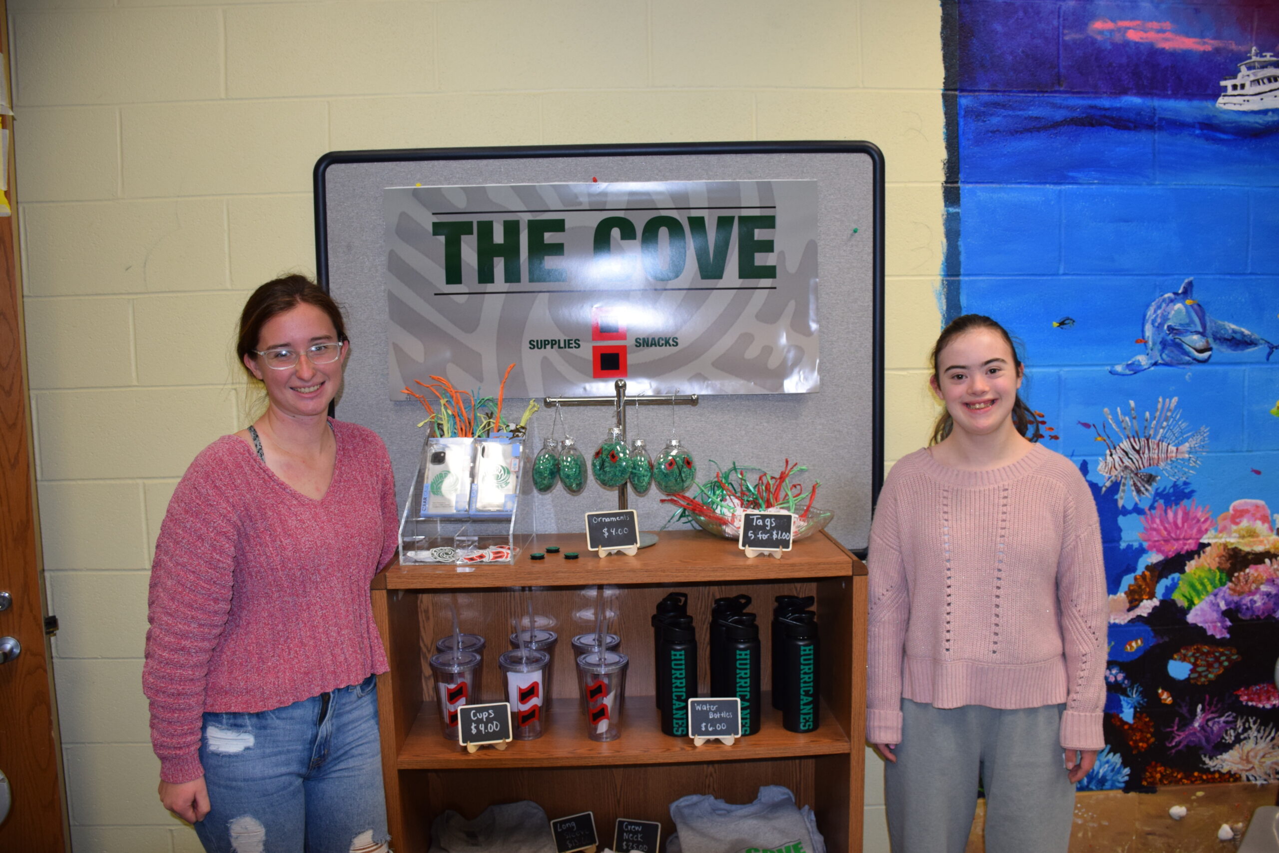 A new school store at Westhampton Beach High School is providing leadership
opportunities for both special education and general education students who are working
together to manage it. The Cove was founded after special education teacher Alison Hansson visited a similar store at Southampton High School and saw how it allowed students to learn about the various aspects of running a business, including marketing, customer service and everyday logistics.
With the support of administrators, members of the high school’s special education program worked with fellow teachers and local businesses to get the store off the ground.
The Cove features snacks, drinks, seasonal crafts, T-shirts, personal care products, and
muffins and cookies donated by Justin’s Chip Shop. Coffee is made using a coffee maker
donated by Hampton Coffee. Math students assisted in pricing the products. COURTESY WESTHAMPTON BEACH SCHOOL DISTRICT