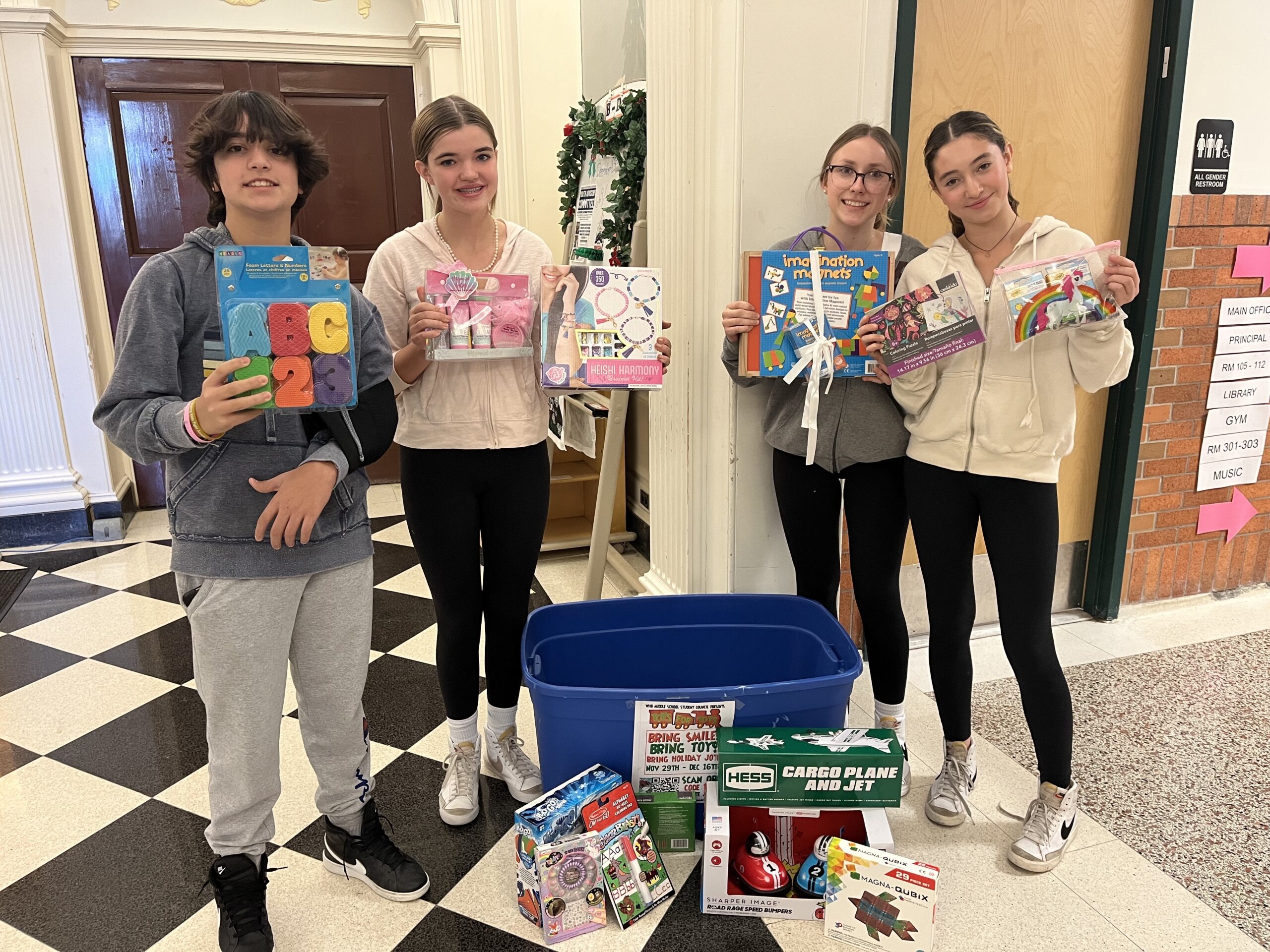 The Westhampton Beach Middle School Student Council has been collecting donations for the Toys for Tots program. They created an online donation drive and set up a donation bin in the front lobby of their school. Additionally, they are raising funds through raffle ticket sales to purchase grocery store gift cards. The gift cards will be donated to families in need through the Church of the Immaculate Conception Food Pantry. From left, council members Nico Grazina, Abigail Halloran, Weronika Mikucka and Annabelle Emerson-Molinoff. COURTESY WESTHAMPTON BEACH SCHOOL DISTRICT