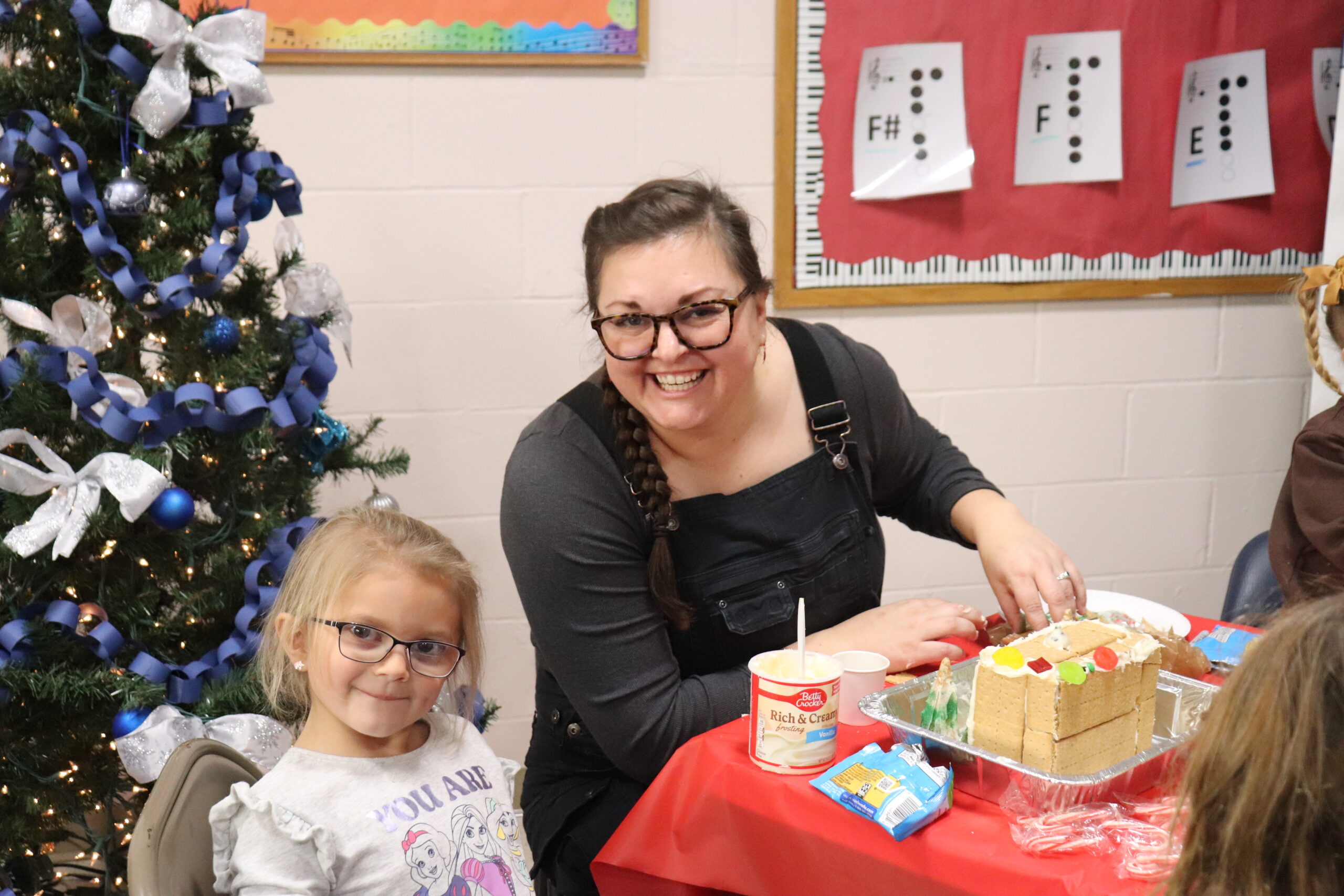 The preKindergarten students of Raynor Country Day School recently hosted their  annual gingerbread build for friends and family.  
Upon arrival, the teams received all the supplies and instructions needed to turn their icing, candies, sprinkles, and graham crackers into designer mansions, ski chalets, outdoor landscapes, and of course, gingerbread houses. Phoebe Brand with her Aunt 