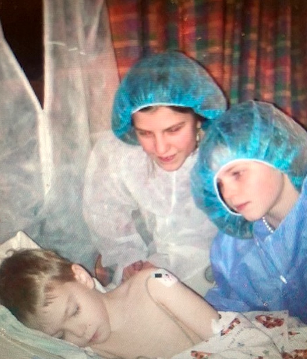 Gavin Vander Schaaf in a hospital bed with his older sisters Lily and Marin. REGINA VANDER SCHAAF