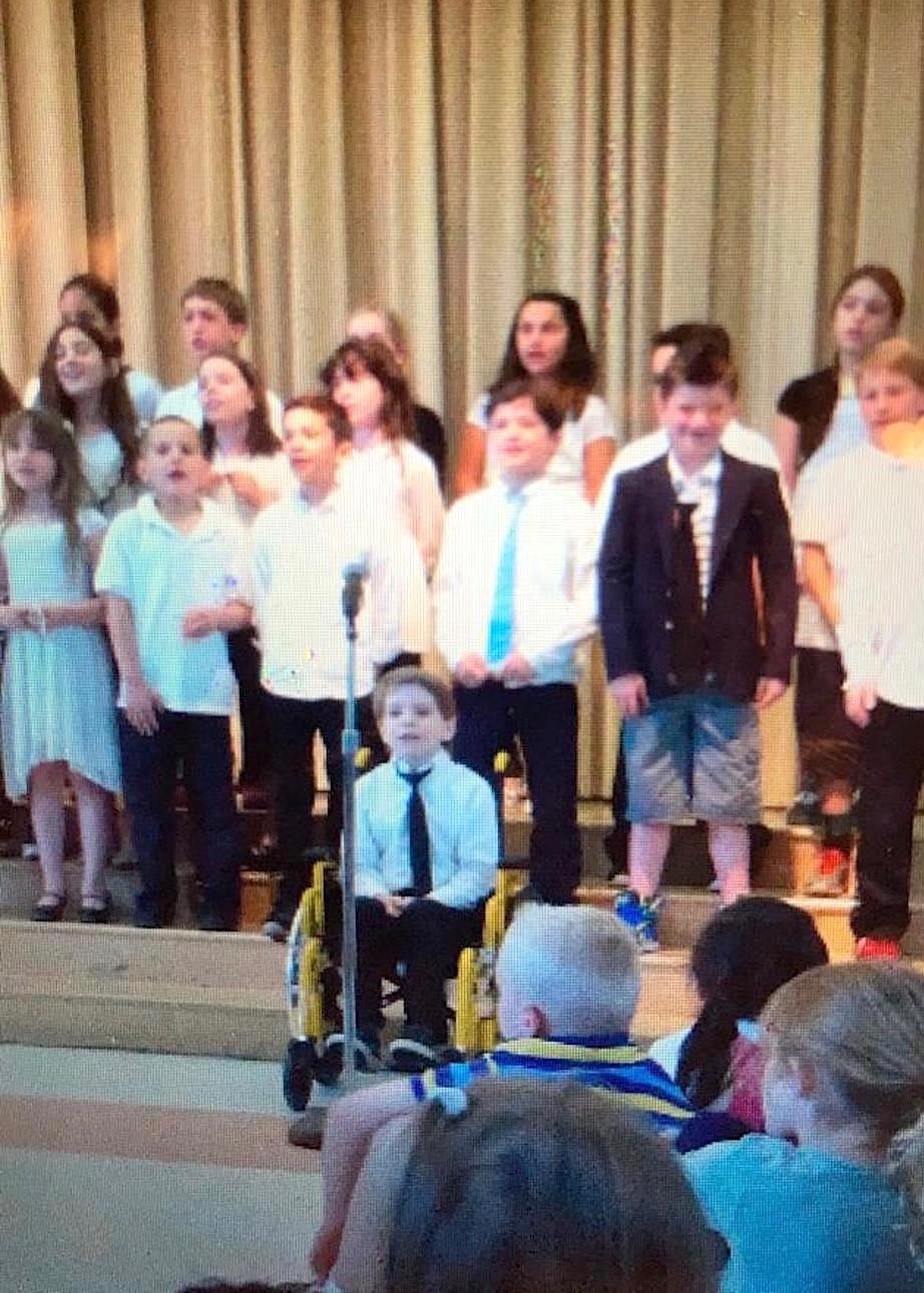 Gavin Vander Schaaf in his wheelchair singing for the East Quogue Elementary School chorus. REGINA VANDER SCHAAF