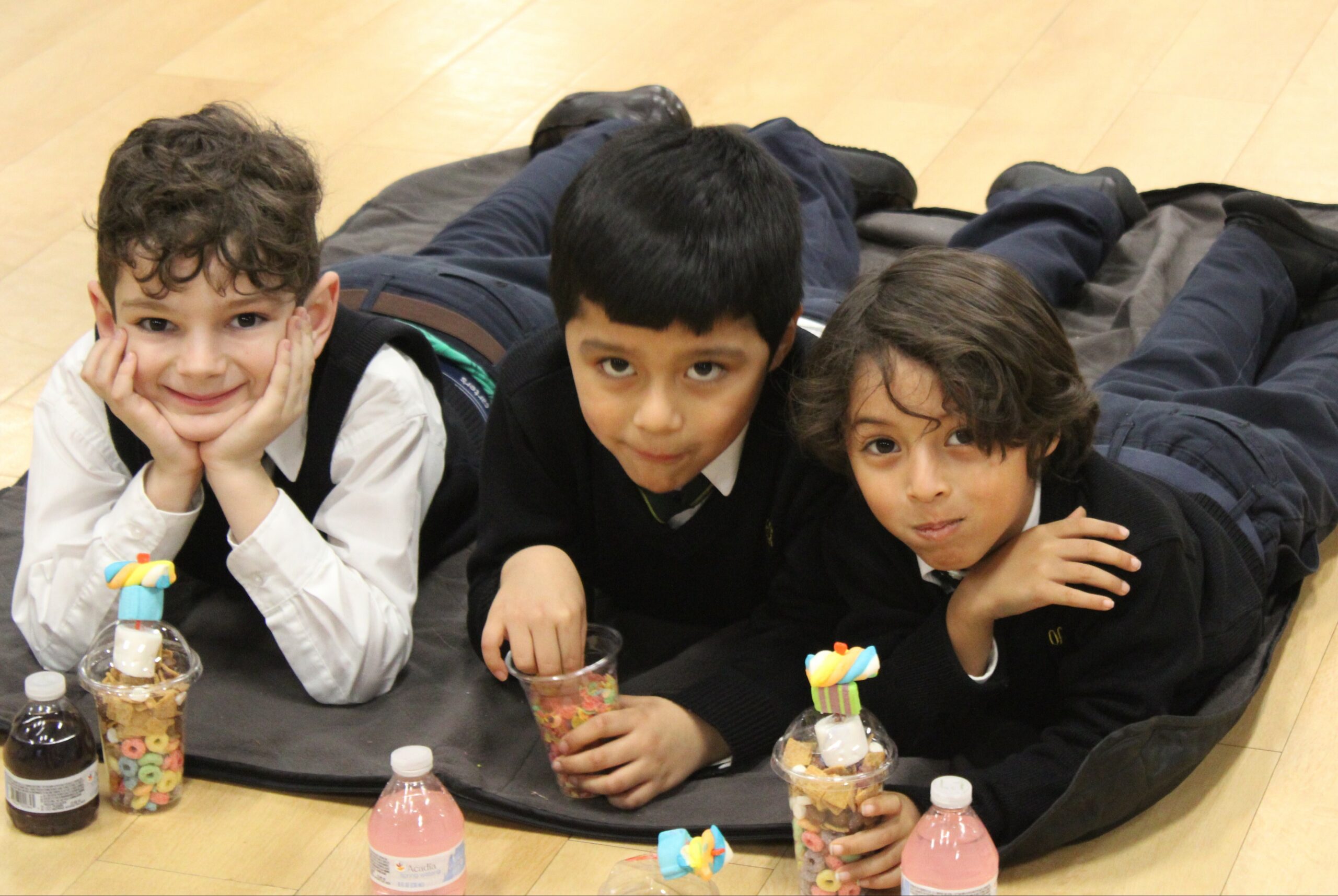 Our Lady of the Hamptons School first-graders, from left, Erik von Carp, Matthew Torres and Lucas Sinche,  enjoyed an after-school movie event at the school recently.  COURTESY OUR LADY OF THE HAMPTONS SCHOOL