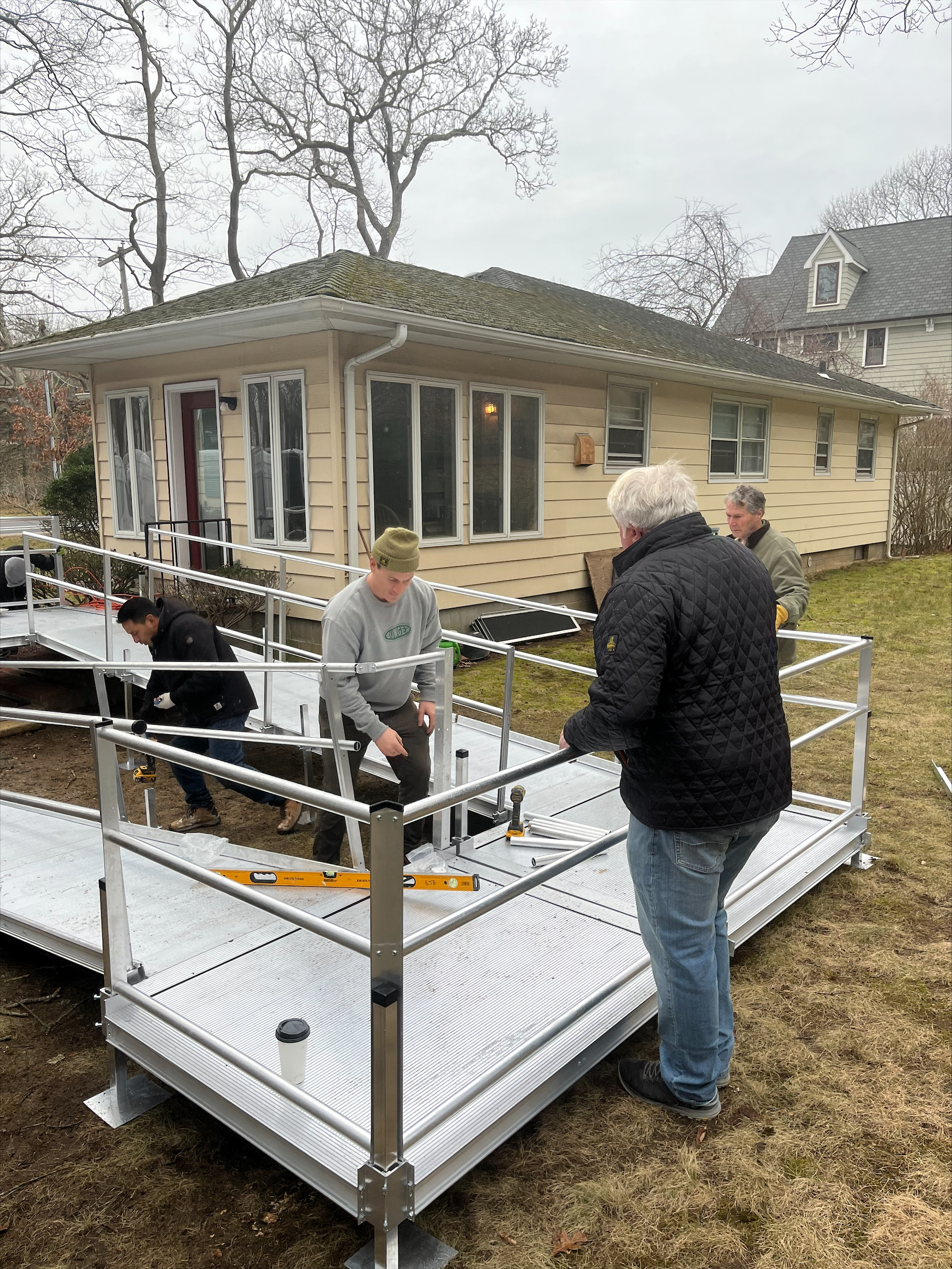A team of volunteers installs a wheelchair ramp for a Sag Harbor resident in need. JON DIAT