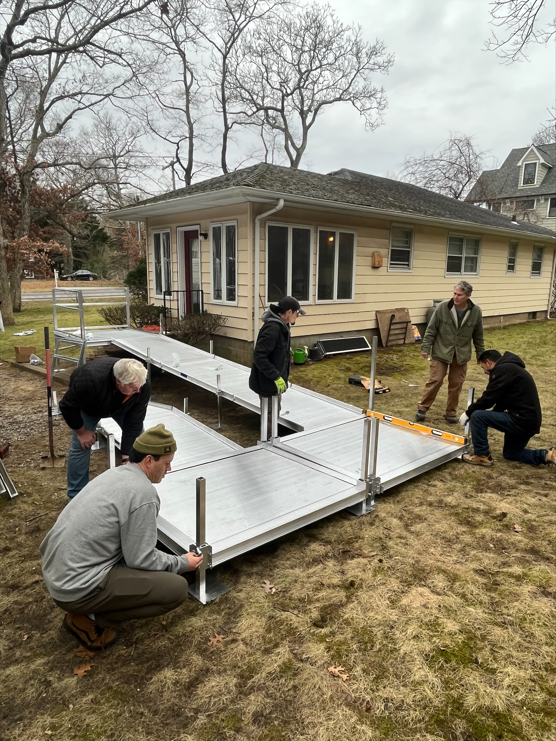 A team of volunteers installs a wheelchair ramp for a Sag Harbor resident in need. JON DIAT