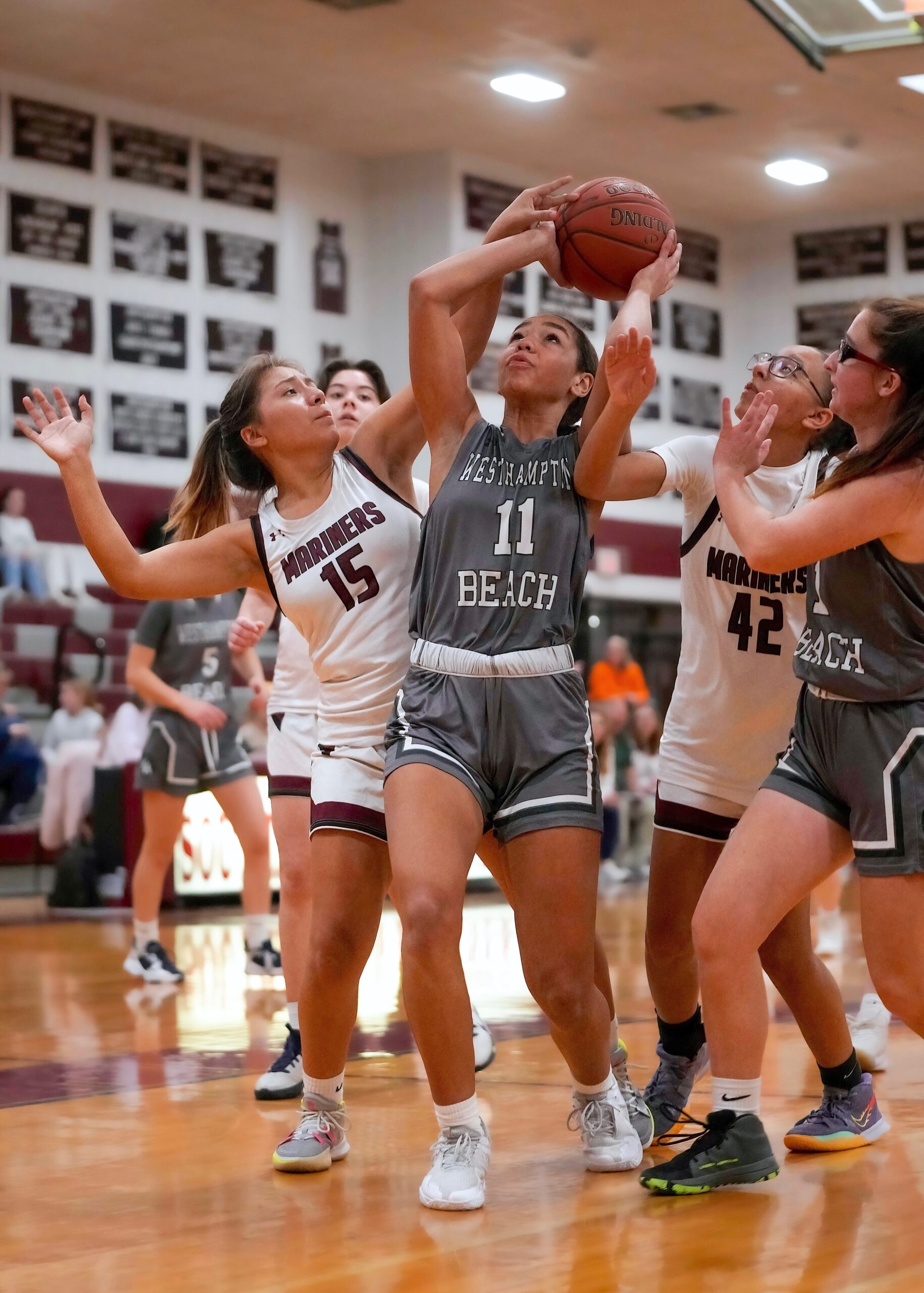 Westhampton Beach freshman Jasmine Taylor reaches for the rim between Southampton's Danna Game and Amadyah Palmore. RON ESPOSITO