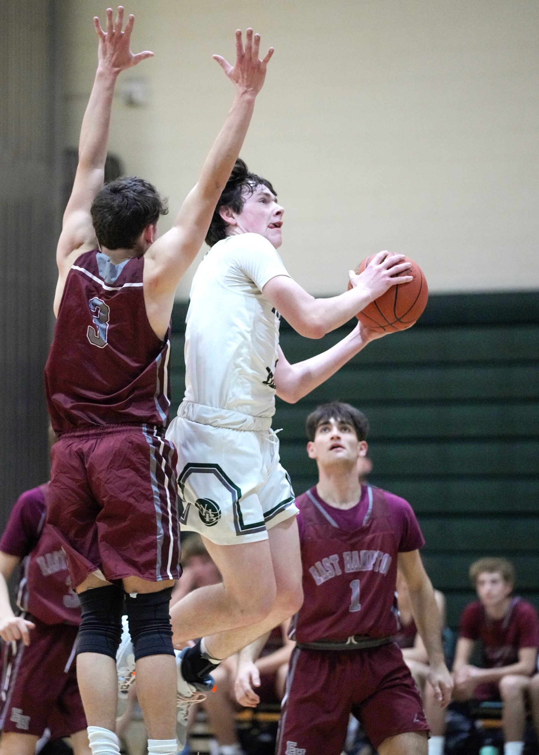 Senior Quinn McCormack reaches for the rim in a game against East Hampton. RON ESPOSITO