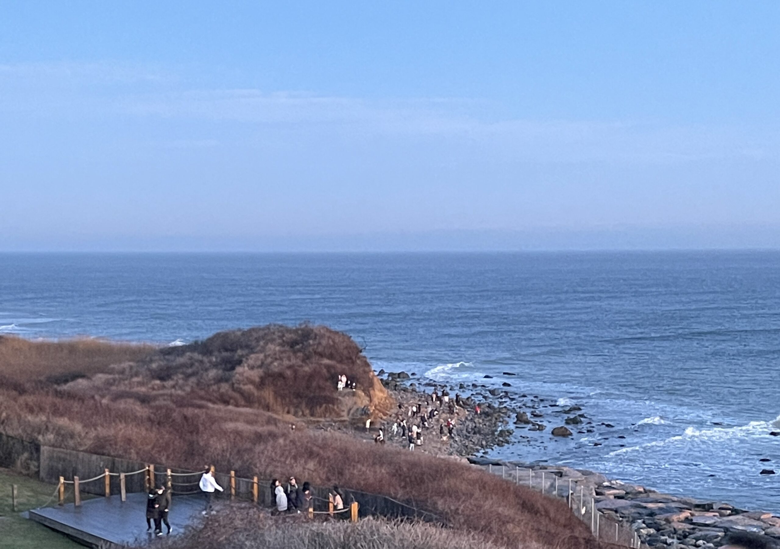 One group of visitors watched the sunrise from the shore below the Montauk Point Lighthouse on New Year's Day.     KATHERINE C.H.E.