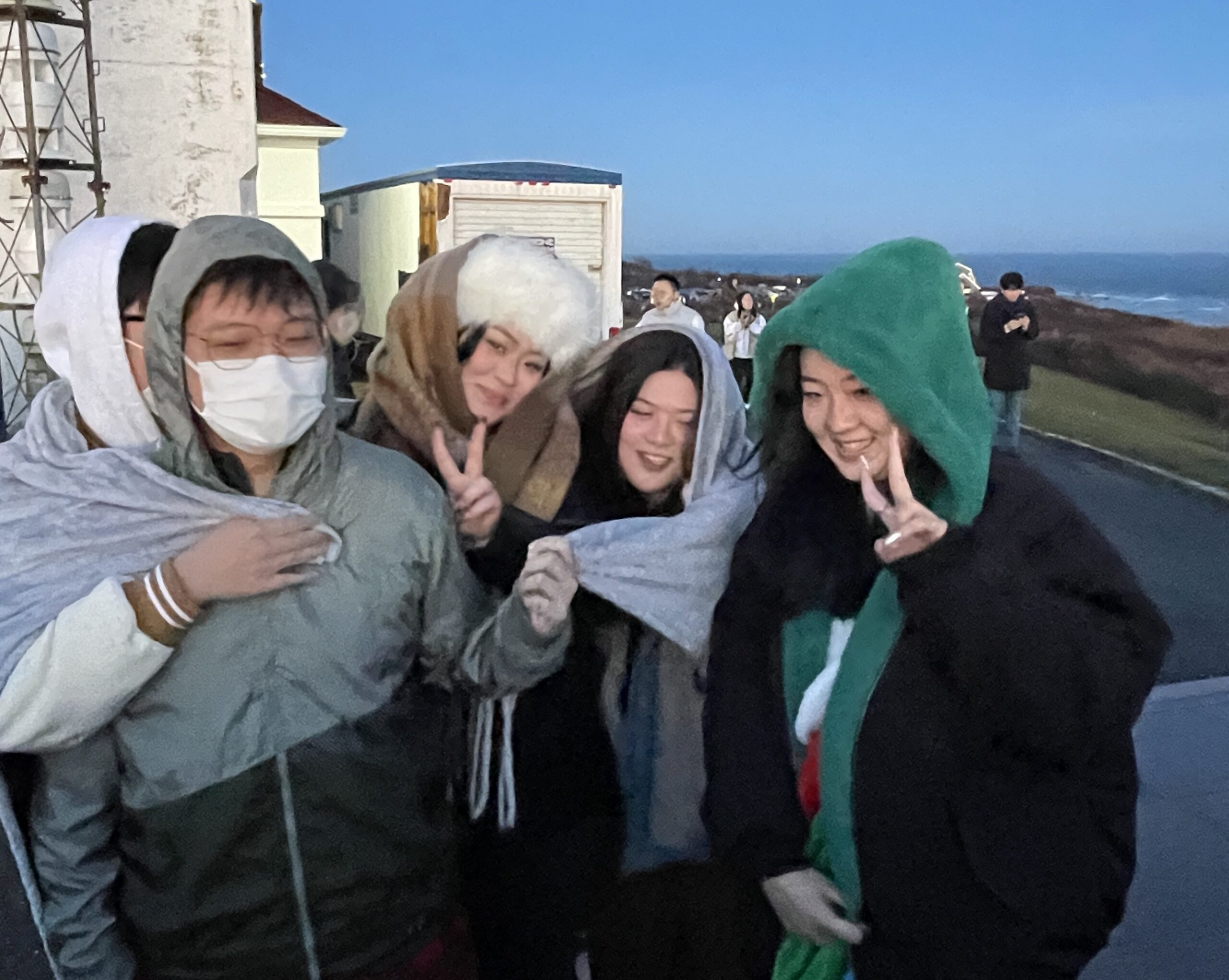 Yvonne Zheng ( center, in white hat) drove out from Flushing with friends to greet the first sunrise of the New Year at the Montauk Point Lighthouse.   KATHERINE C.H.E.