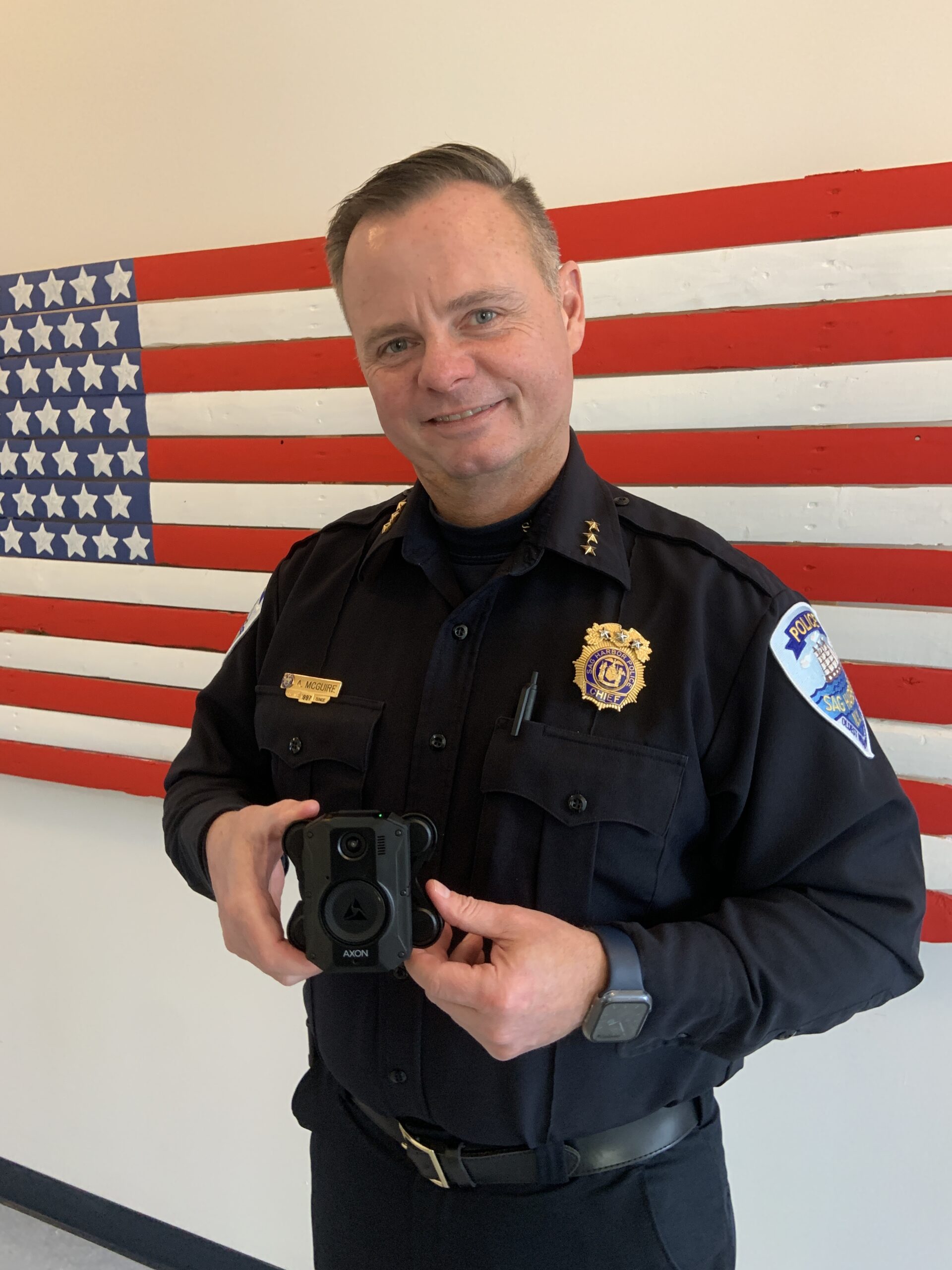 Sag Harbor Village Police Chief Austin J. McGuire with one of the body cameras village officers will soon be wearing. STEPHEN J. KOTZ