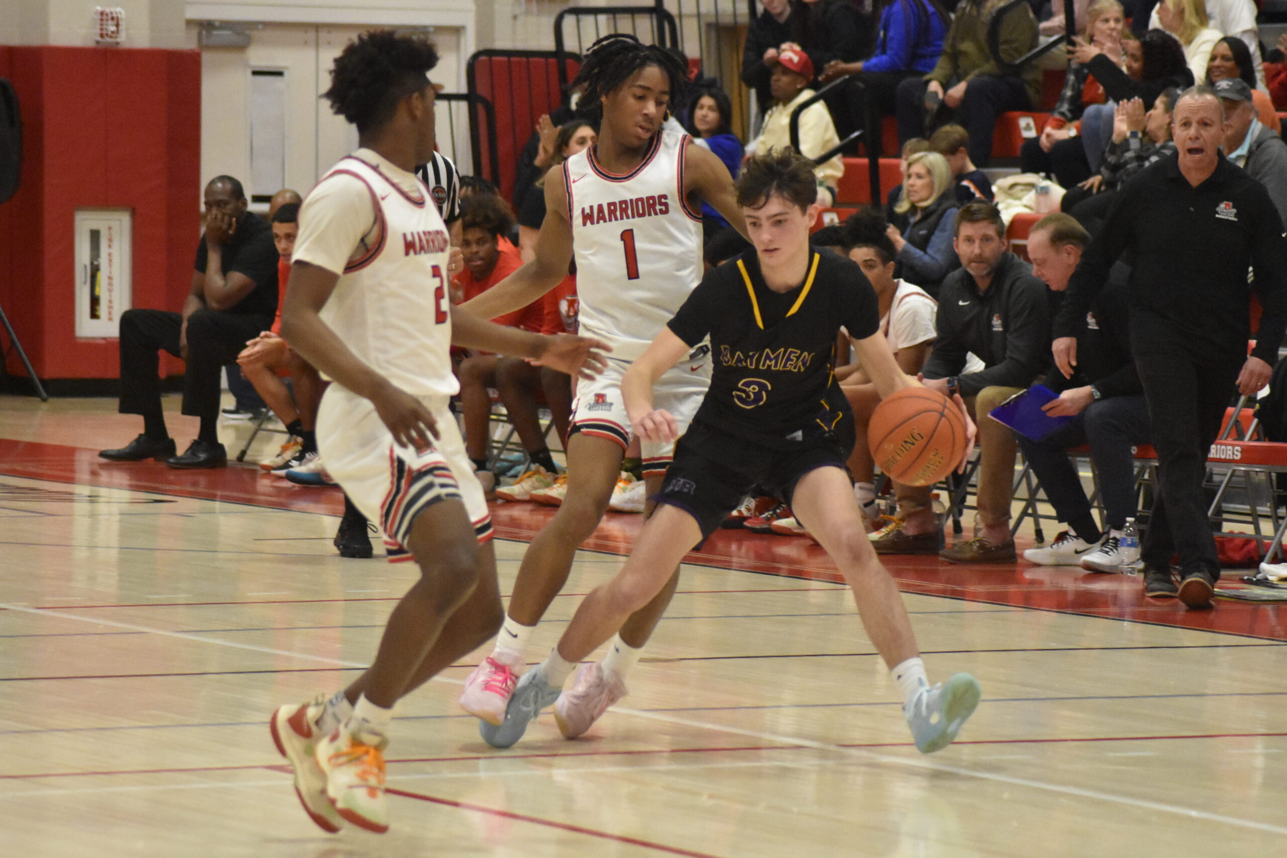 Hampton Bays junior James Powers looks to avoid Amityville defenders.   DREW BUDD