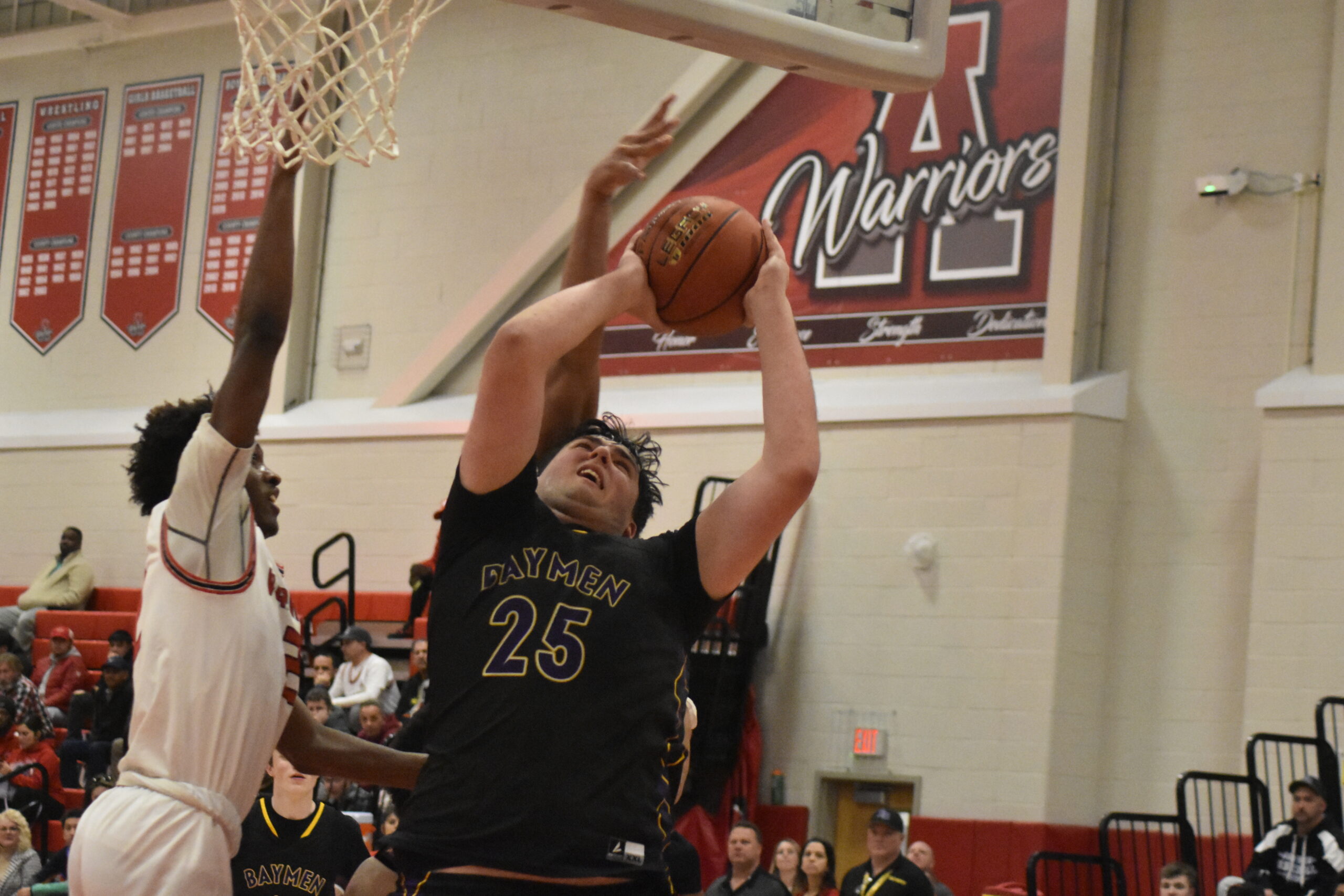 Hampton Bays junior Isaiah Lattanzio appears to be fouled.    DREW BUDD