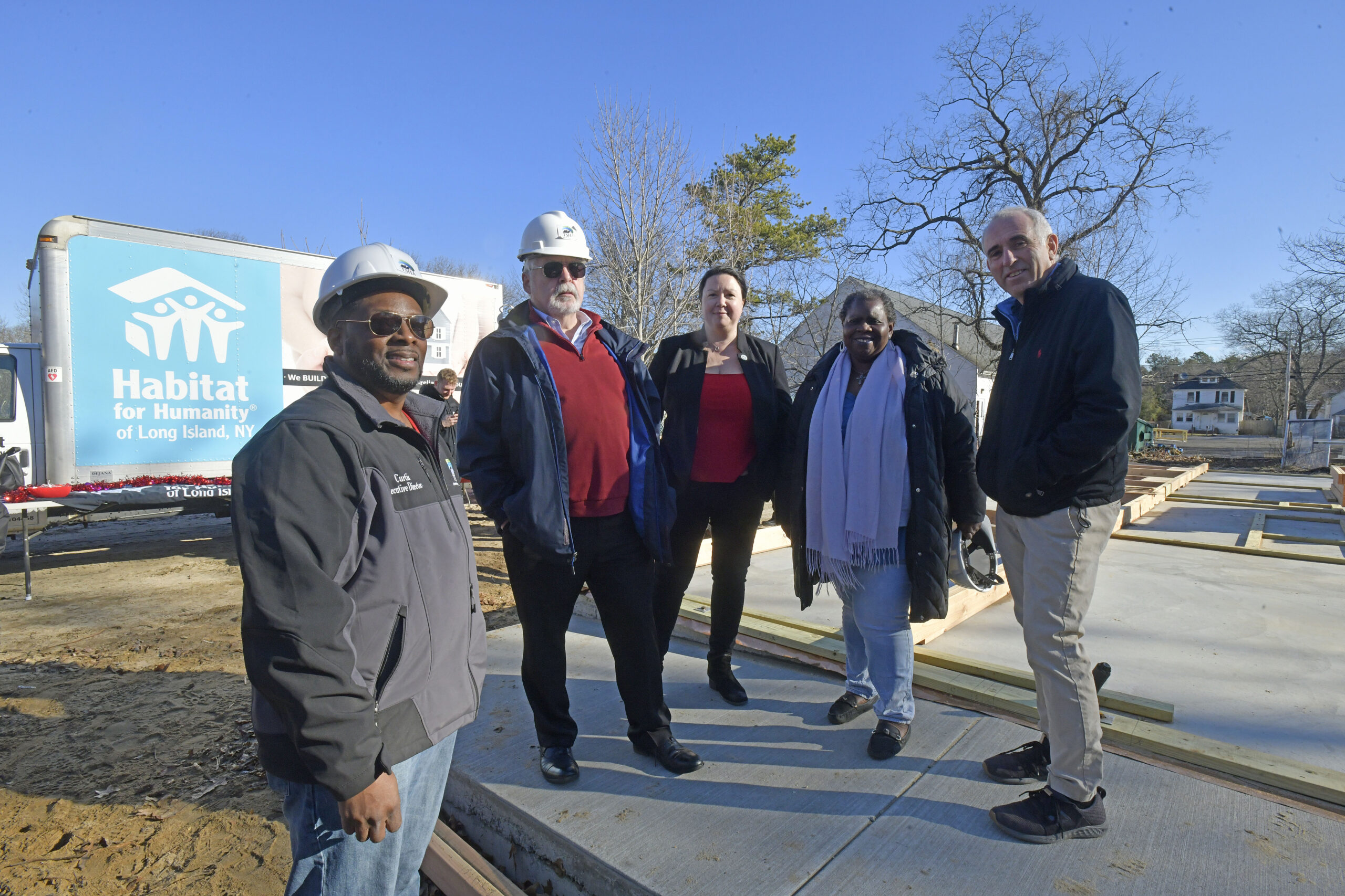 Executive Director of the Southampton Town Housing Authority Curtis Highsmith, Jr., Southampton Town Councilman John Bouvier, Councilwoman Cyndi McNamara and Town Supervisor Jay Schneiderman at the wall raising at the the Habitat for Humanity house on Vail Avenue in Riverside on Tuesday morning.  DANA SHAW