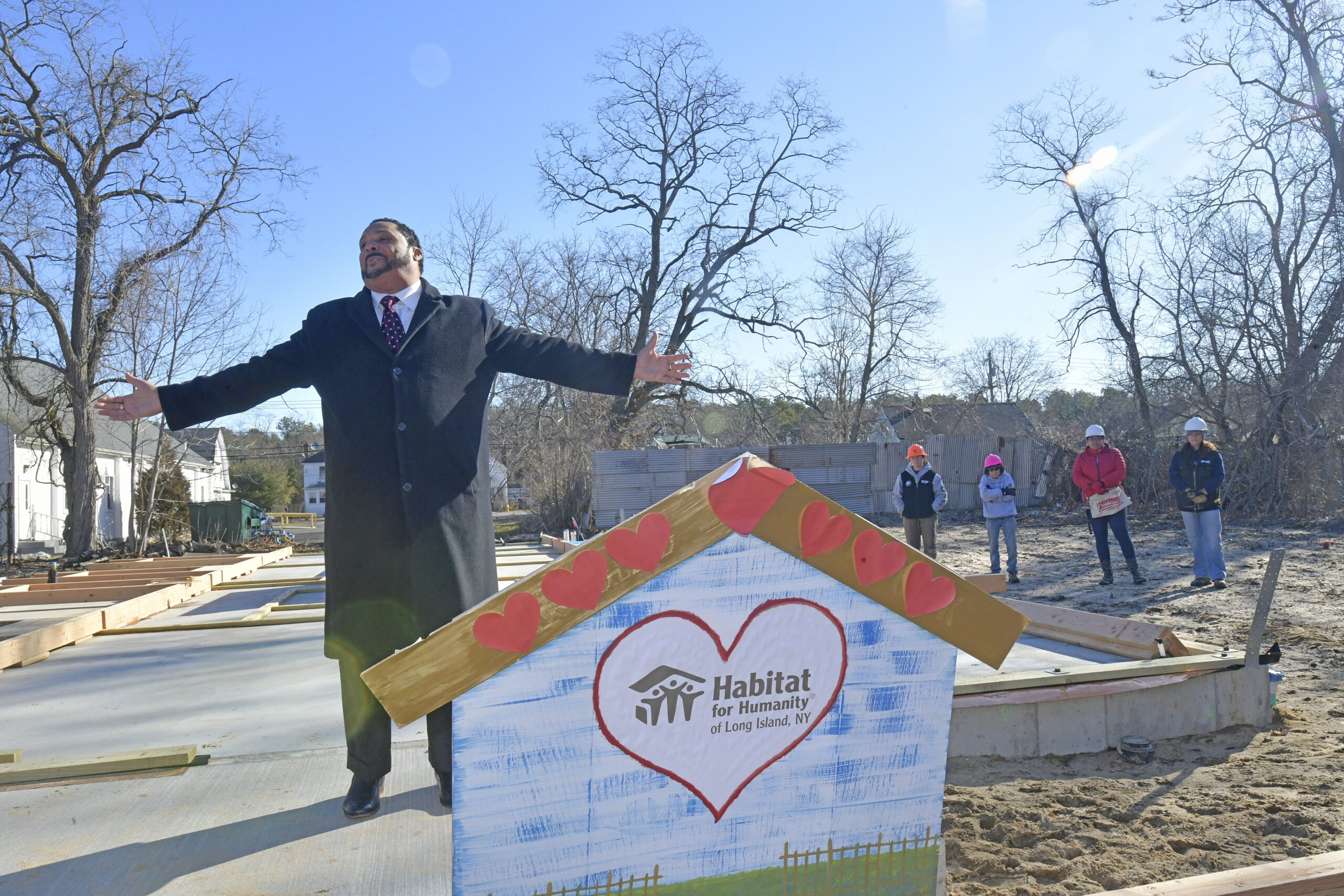 Bishop Harrison Hale, a former Vail Avenue resident and uncle of Southampton Town Housing Authority Executive Director Curtis Highsmith Jr., at the wall raising at the Habitat for Humanity house in riverside on Tuesday morning.   DANA SHAW