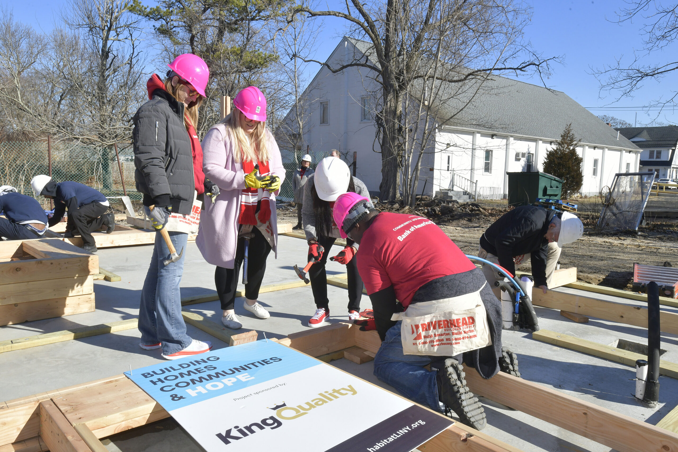 Volunteers raise the walls on the Habitat for Humanity house on Vail Avenue in Riverside on Tuesday morning.  DANA SHAW