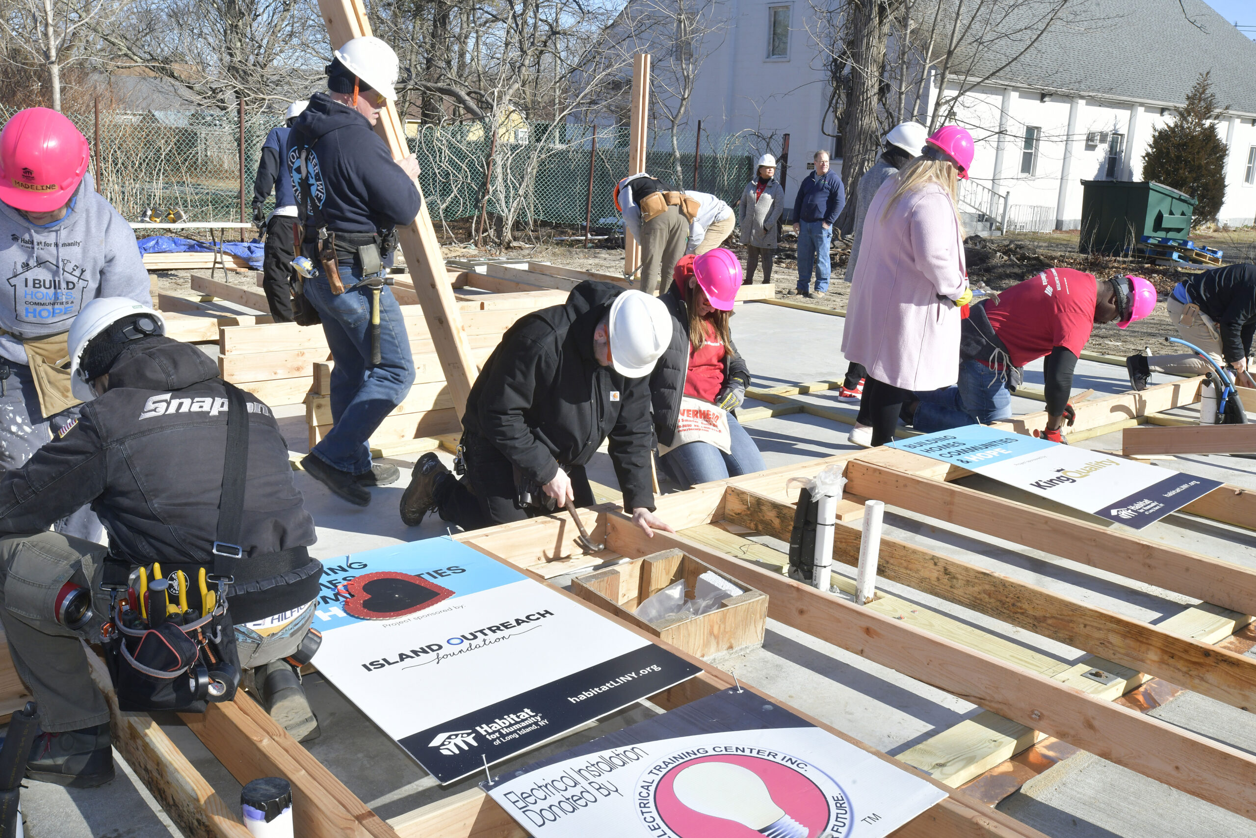 Volunteers raise the walls on the Habitat for Humanity house on Vail Avenue in Riverside on Tuesday morning.  DANA SHAW