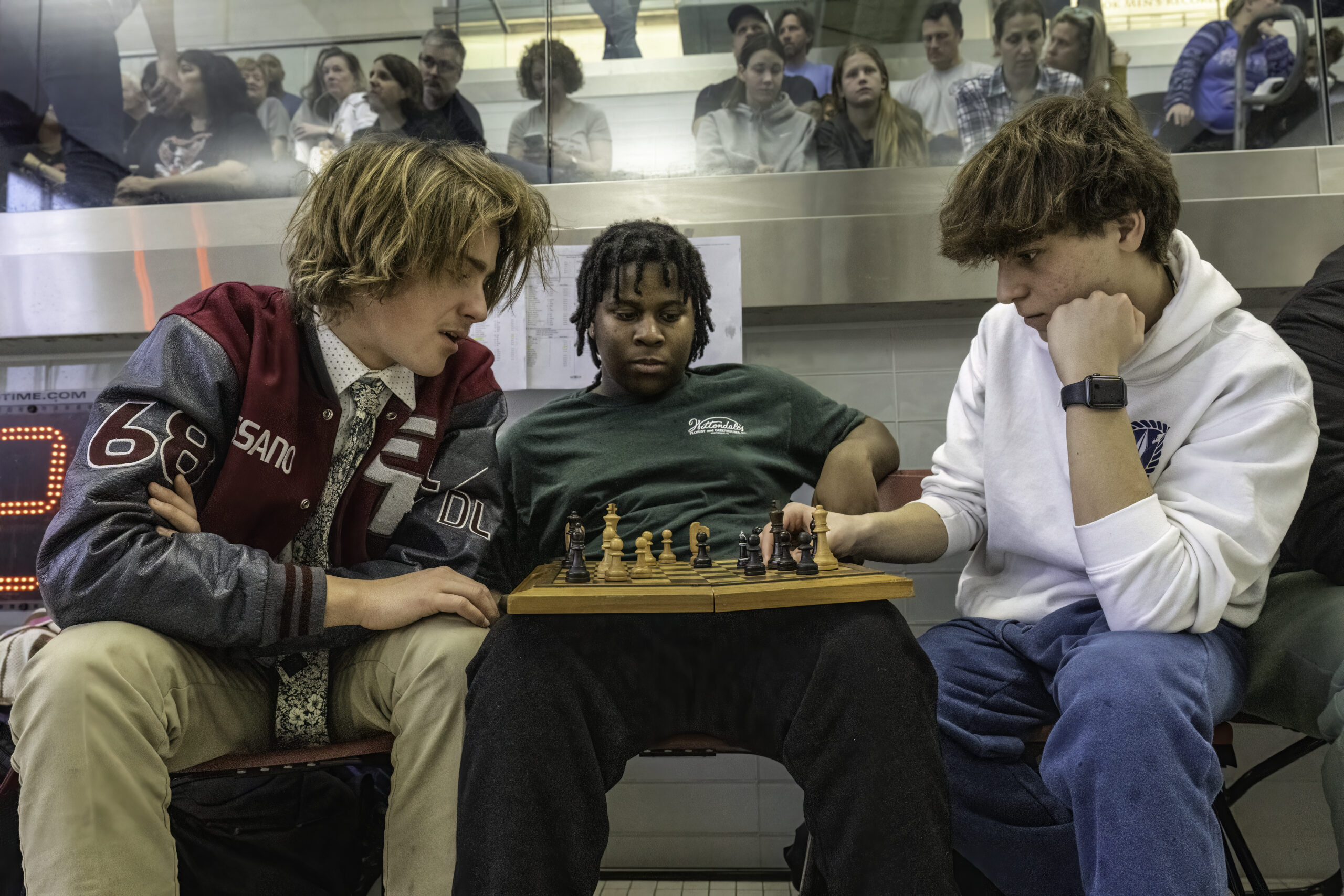 Daniel Rossano, left, Ares Jenkins and Abe Stillman get a game of chess amid all the action on Saturday.  MARIANNE BARNETT