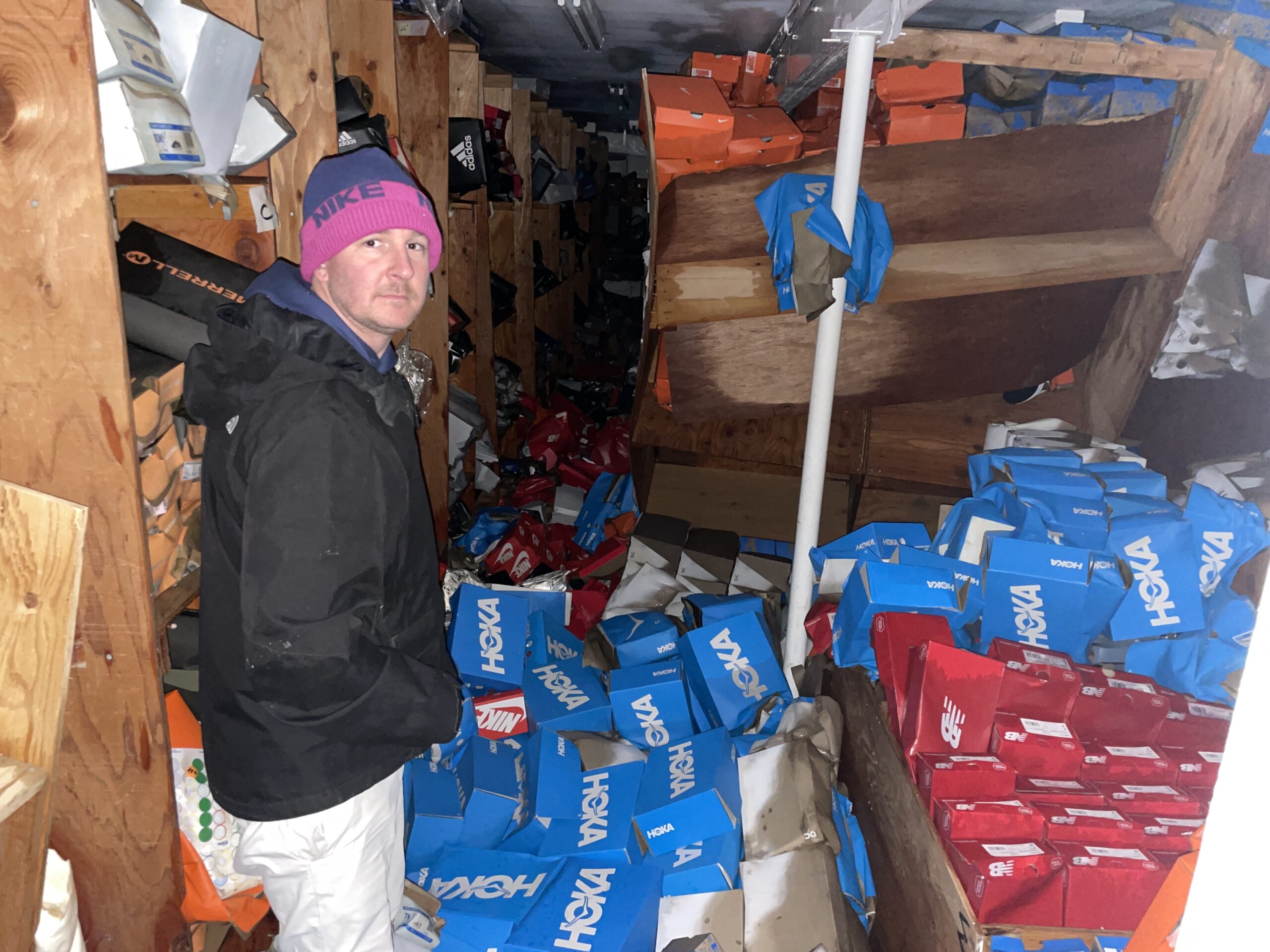 Geary Gubbins in the basement of his family's sporting good shop. Thousands of pairs of shoes will have to be discarded from the store's basement.
Michael Wright