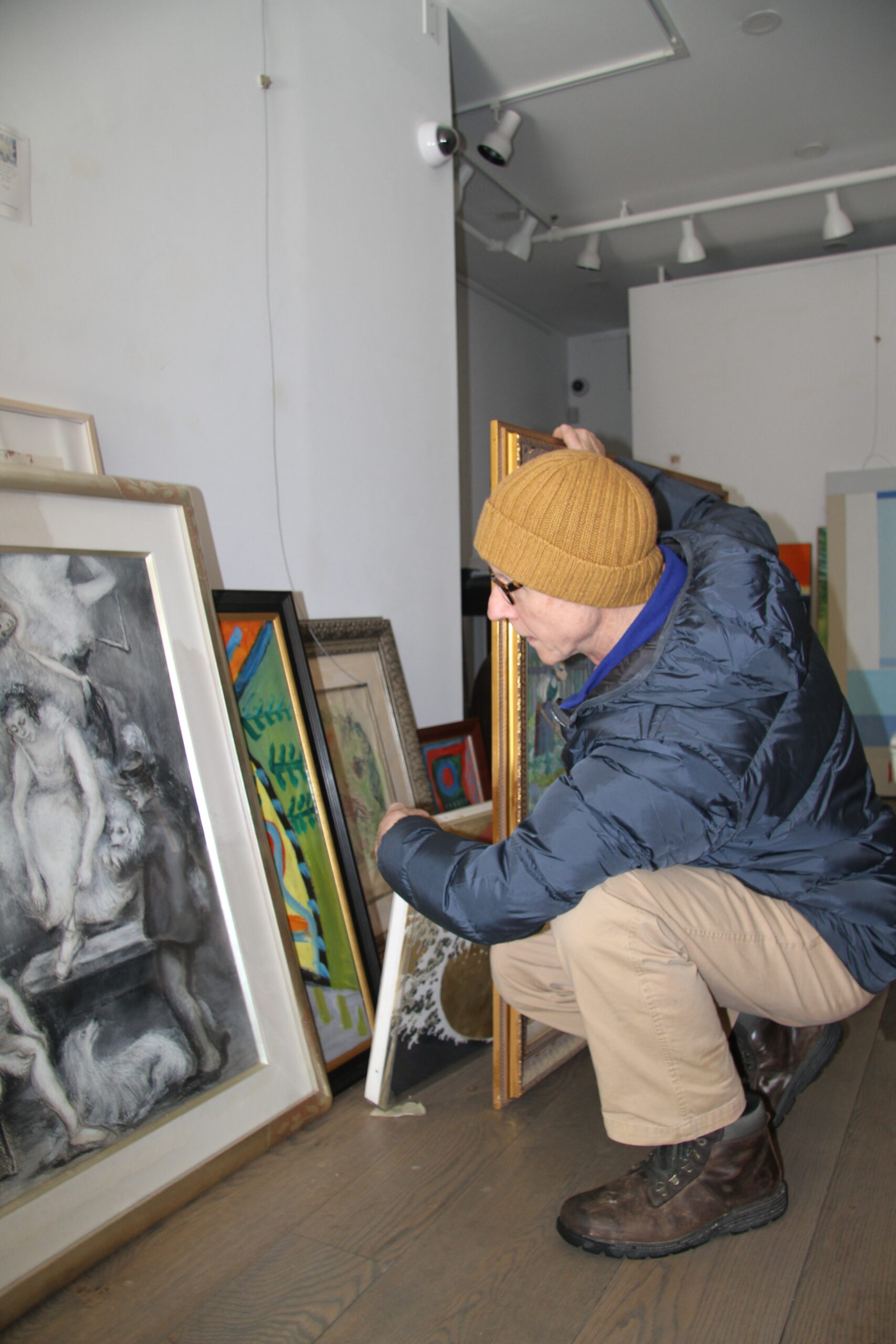 Fine art gallerist Colm Rowan with some of the dozens of valuable and rare paintings that were submerged in the flooded basement of his shop.
Michael Wright