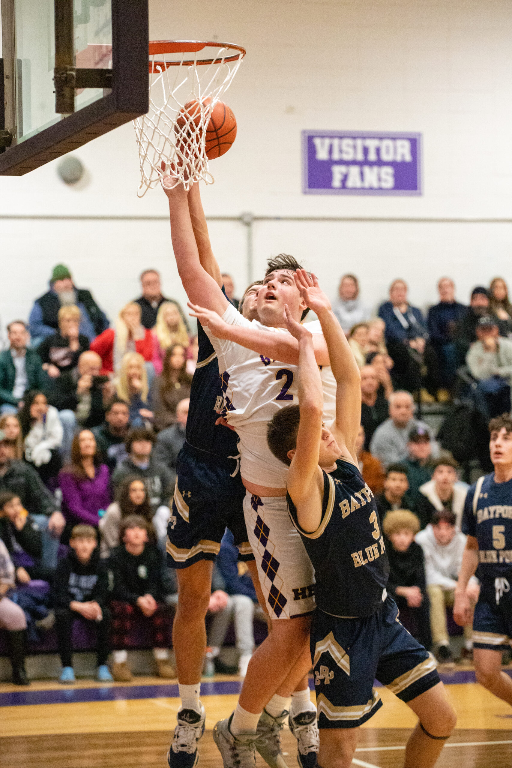 Junior forward Isaiah Lattanzio places the ball into the basket. MICHAEL O'CONNOR