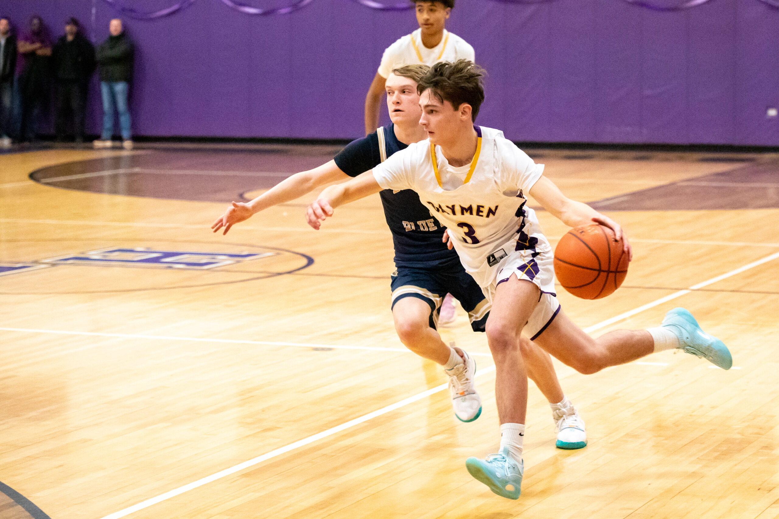 Junior guard James Powers moves the ball down the court. MICHAEL O'CONNOR