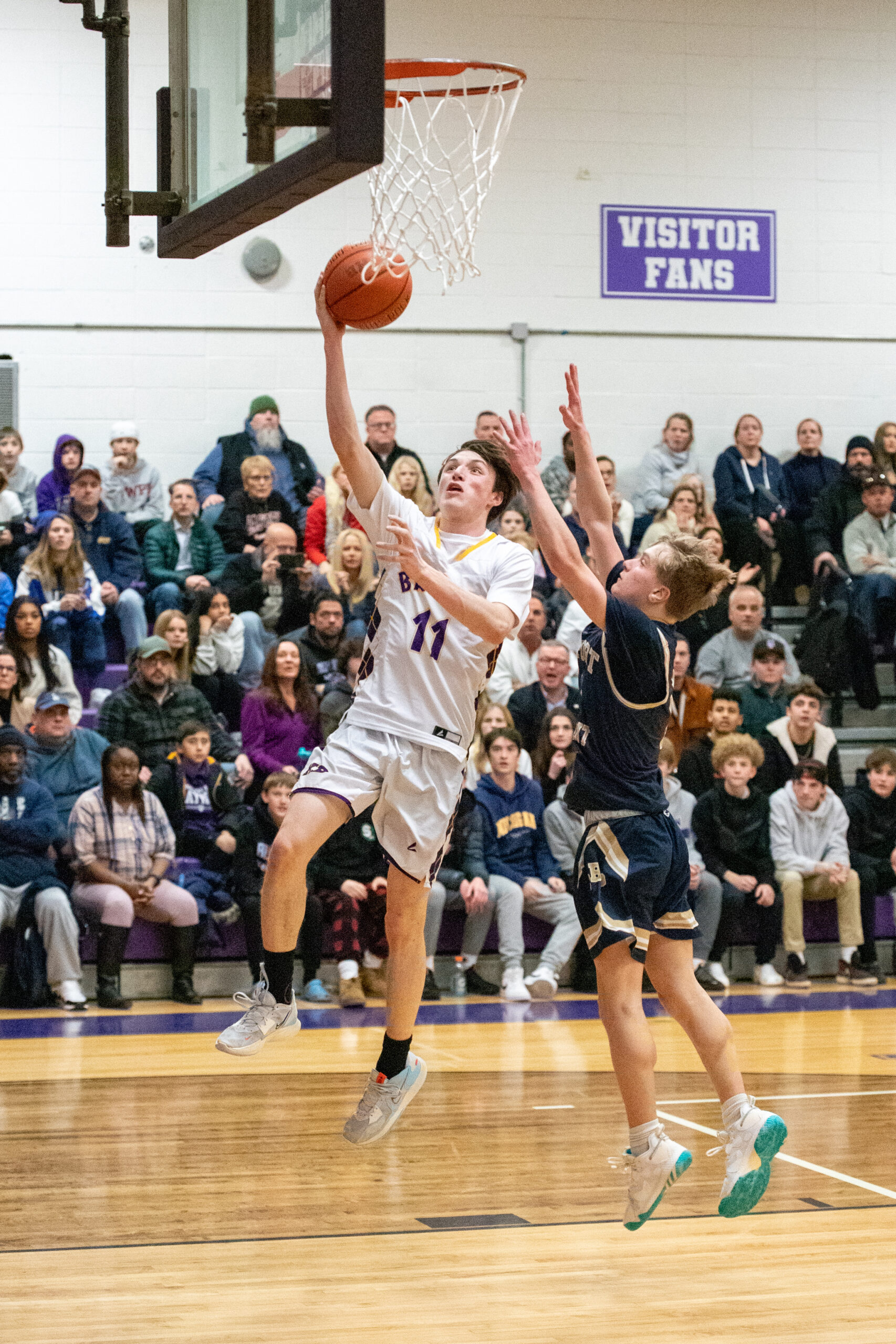 Junior small forward Pat Donahue shoots and scores ahead of Bayport-Blue Point's Robby Maurer. MICHAEL O'CONNOR