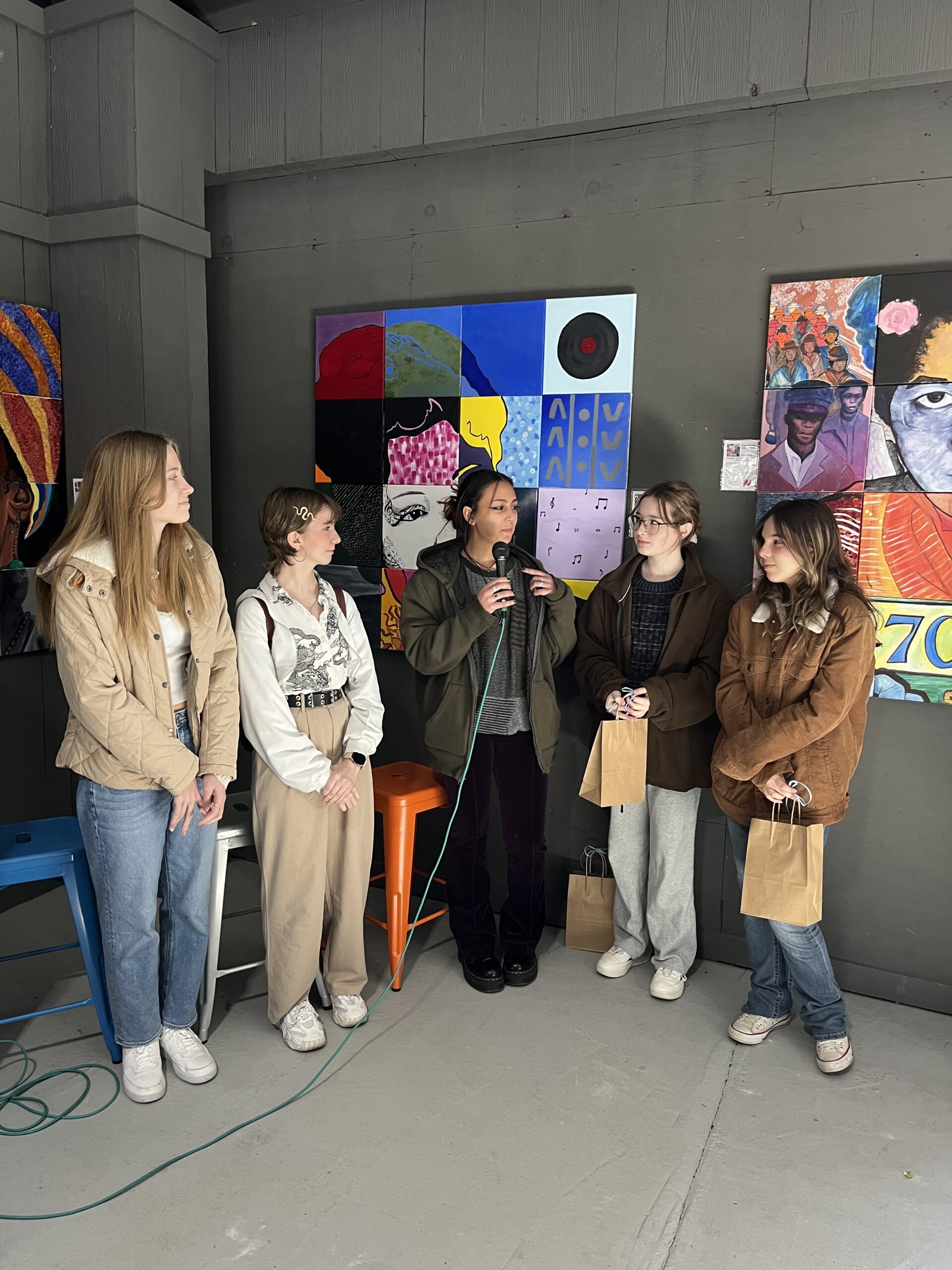 Students speaking about their mosaic murals at the East End Food Market on Saturday. ELIZABETH VESPE