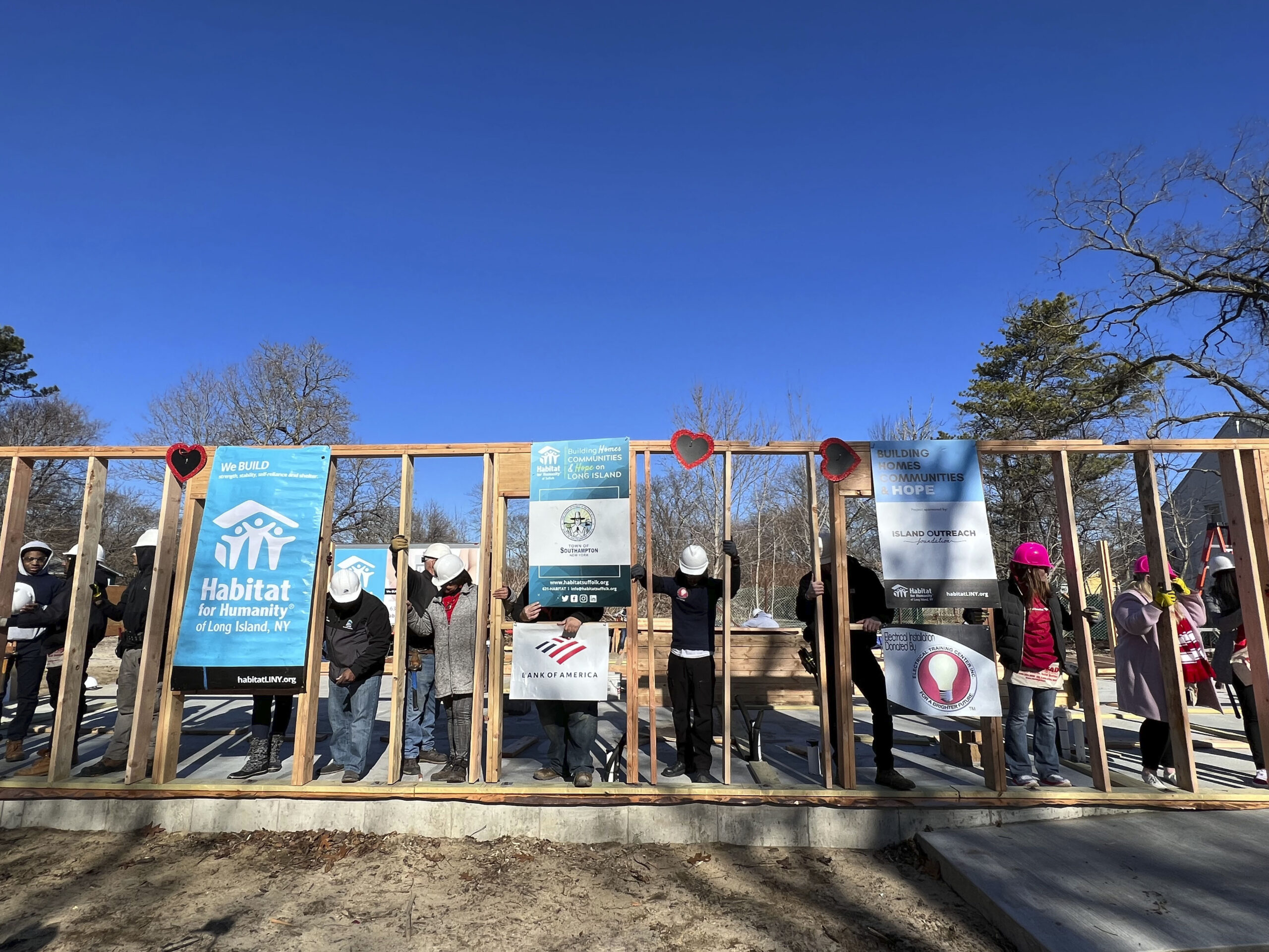 Volunteers raise the walls on the Habitat for Humanity house on Vail Avenue in Riverside on Tuesday morning.  DANA SHAW