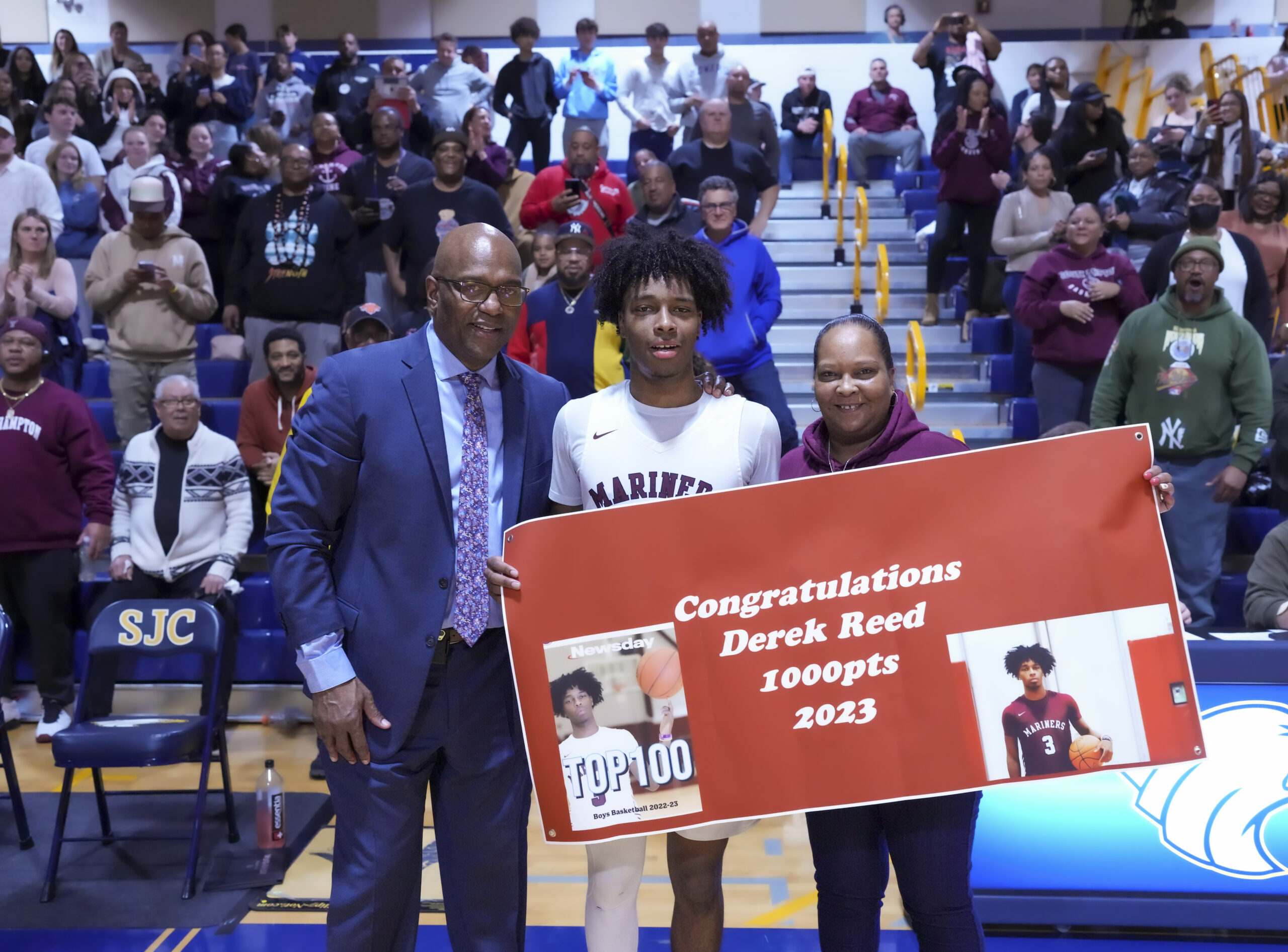 After scoring career points 1,000 and 1,001, play was stopped in the fourth quarter and Derek Reed was honored. His head coach Herm Lamison and his mother Nishwe Williams joined him.   RON ESPOSITO