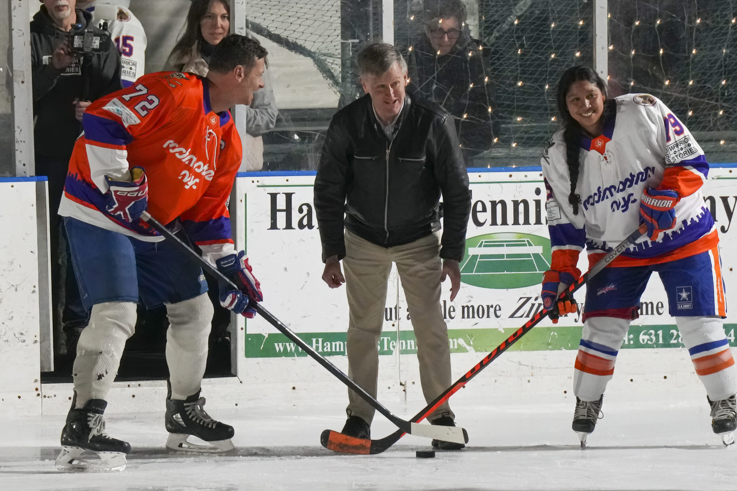 W. Scott Bradley of Mental Health and Awareness drops the ceremonial puck with Michael Sapirstein of Roofmaster NYC, left, and Michael Reis, an Army veteran.    RON ESPOSITO